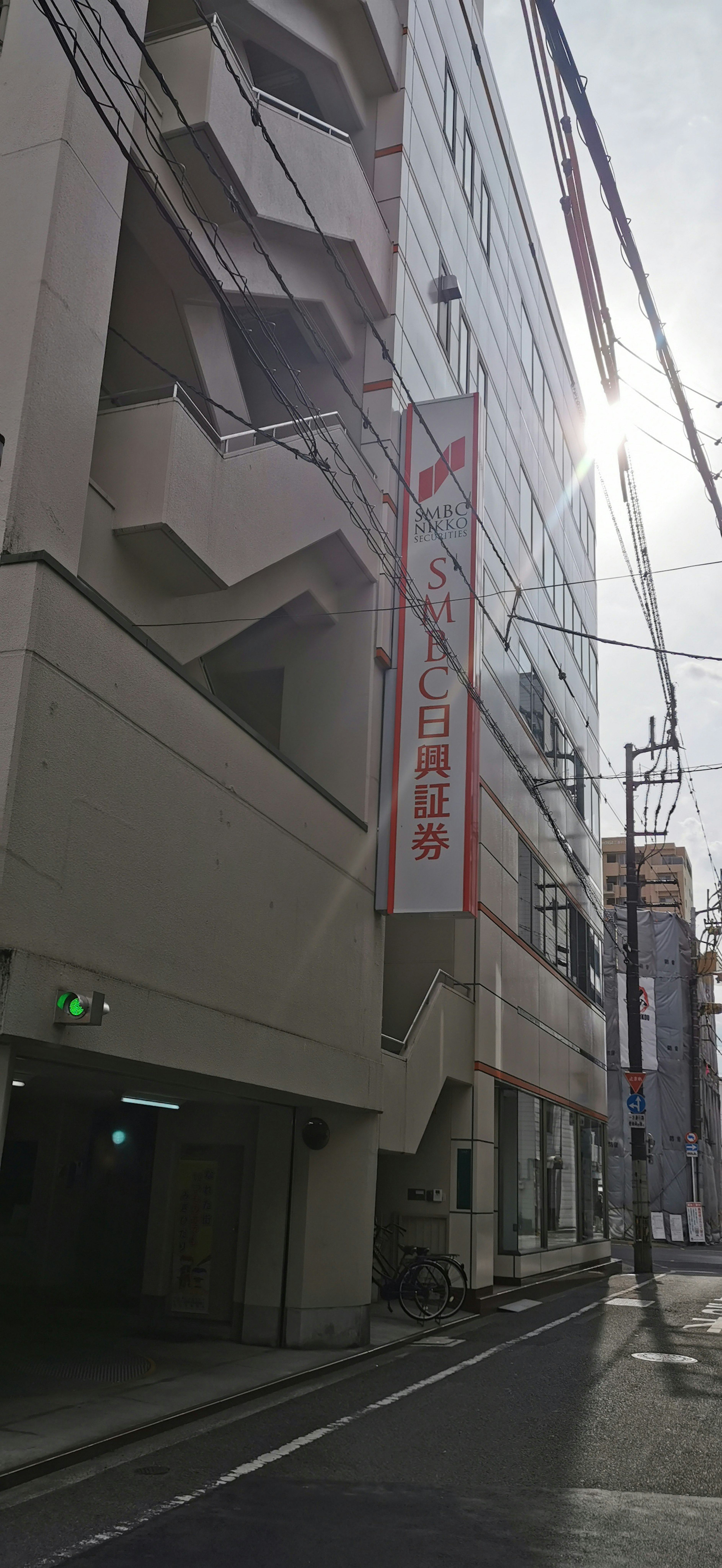 Street view featuring a building facade and a sign