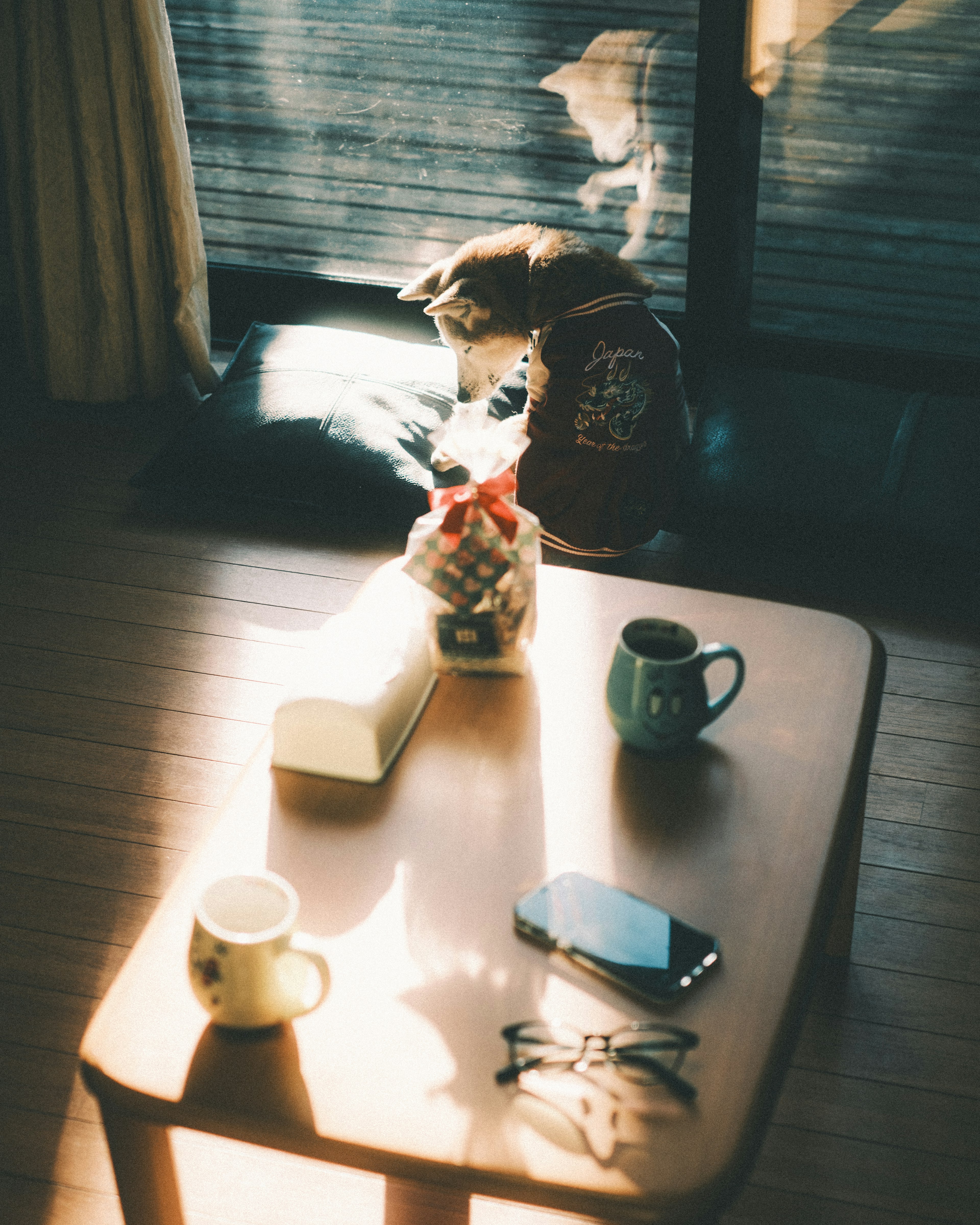 Cozy room scene with coffee cups and smartphone on a wooden table