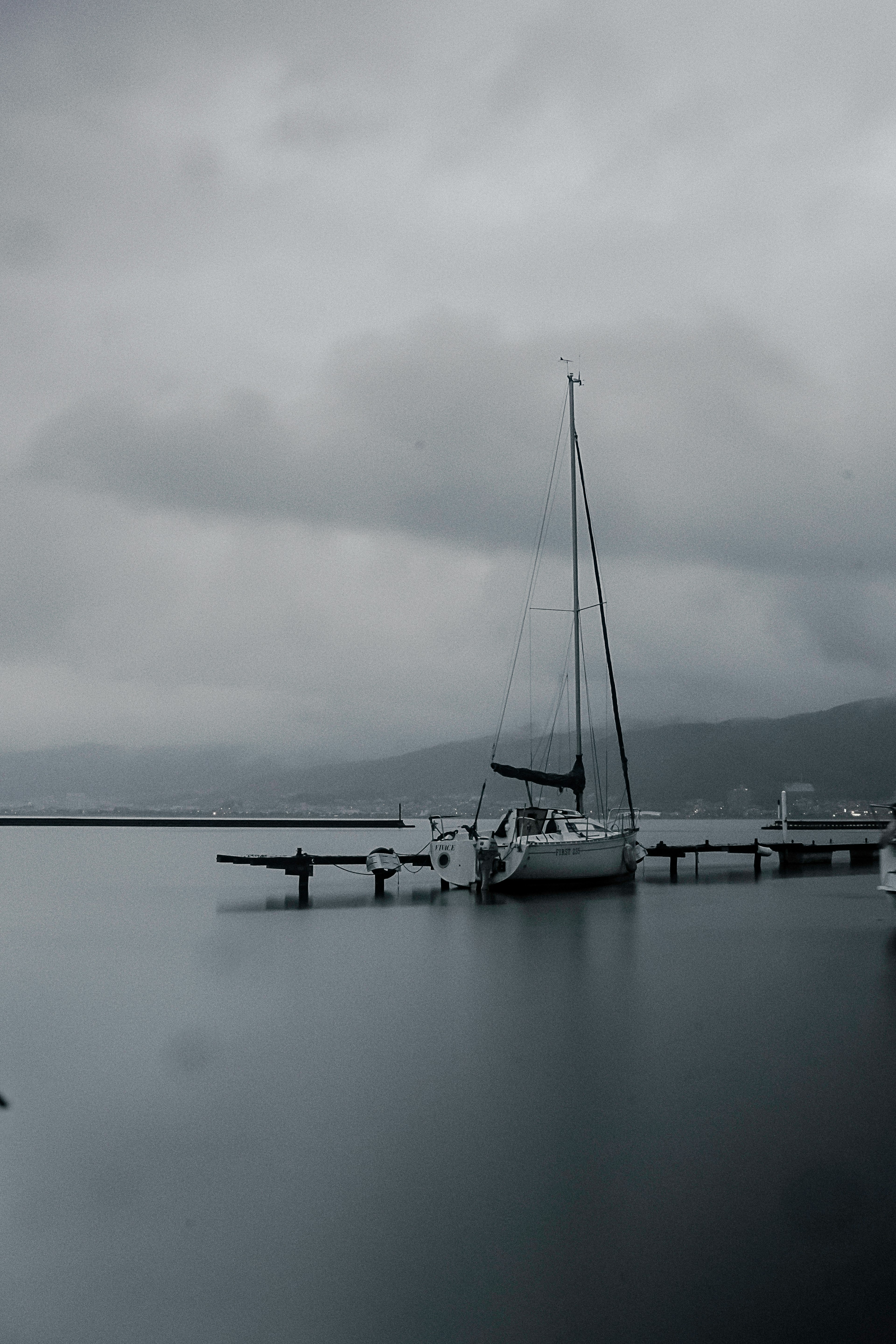 Yacht on calm water under a cloudy sky