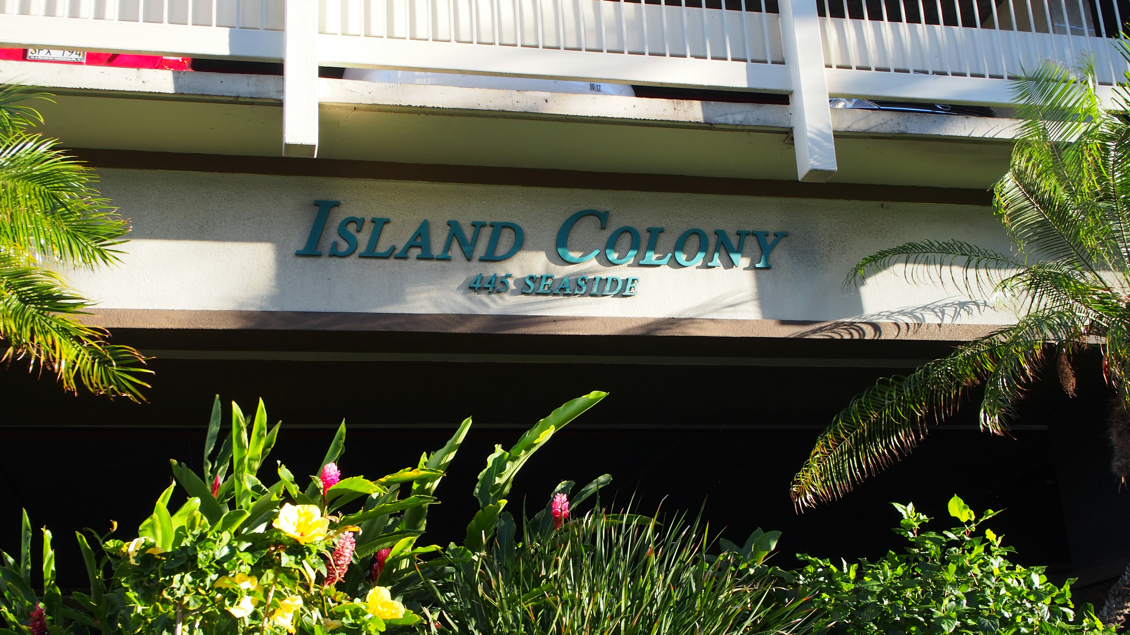 Island Colony sign with lush greenery