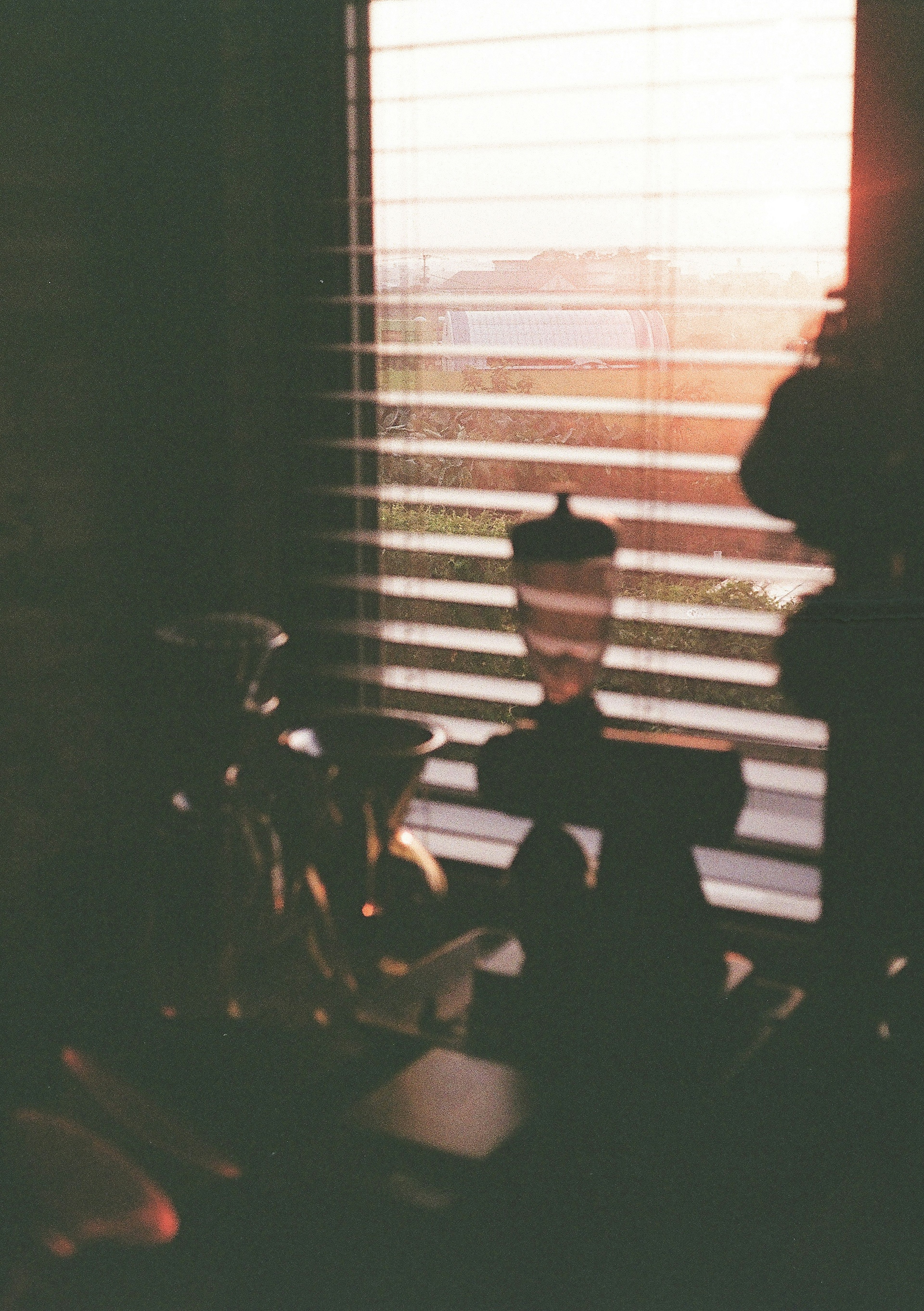 Quiet indoor scene with sunset light filtering through blinds