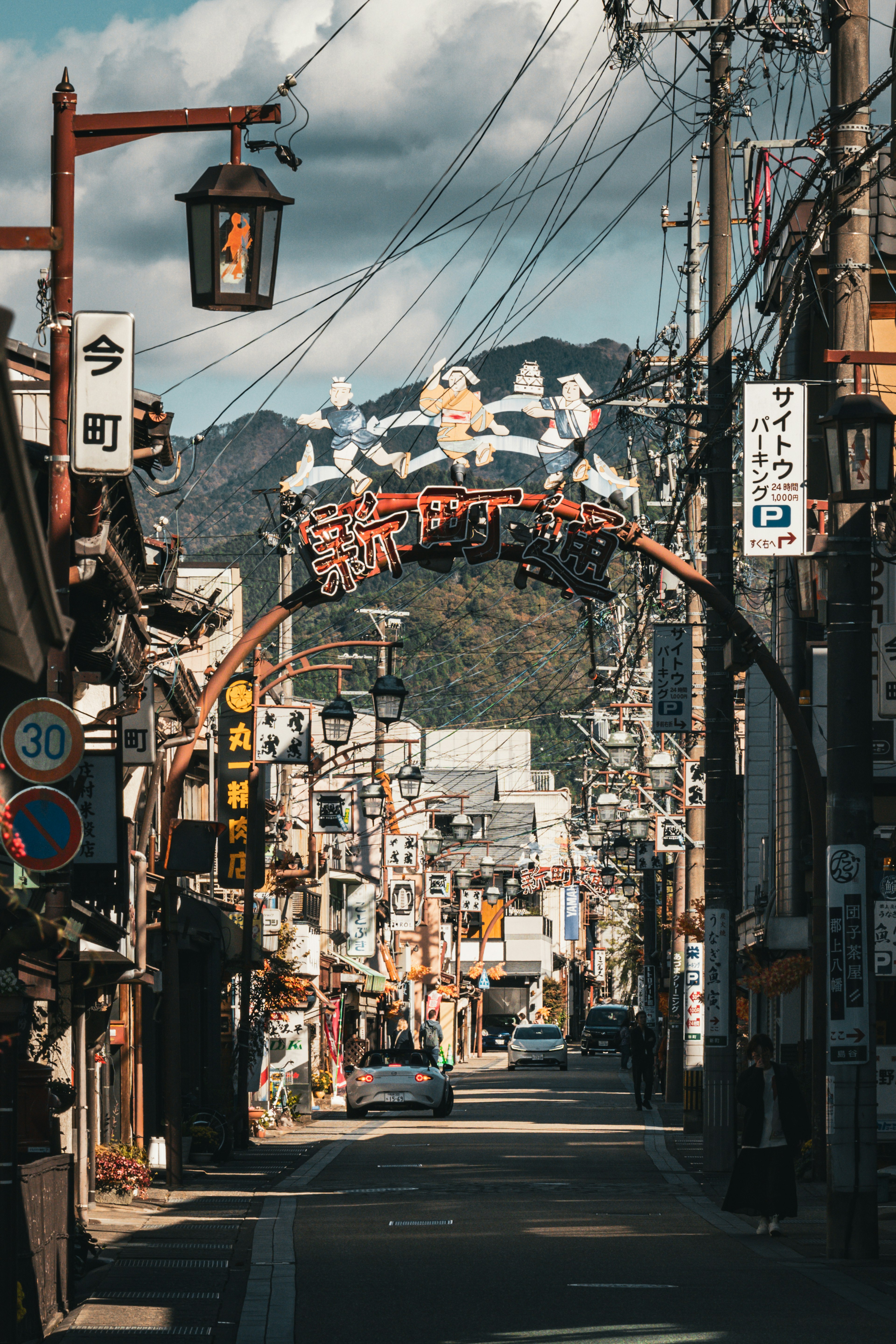 Street scene of a shopping district with mountains in the background