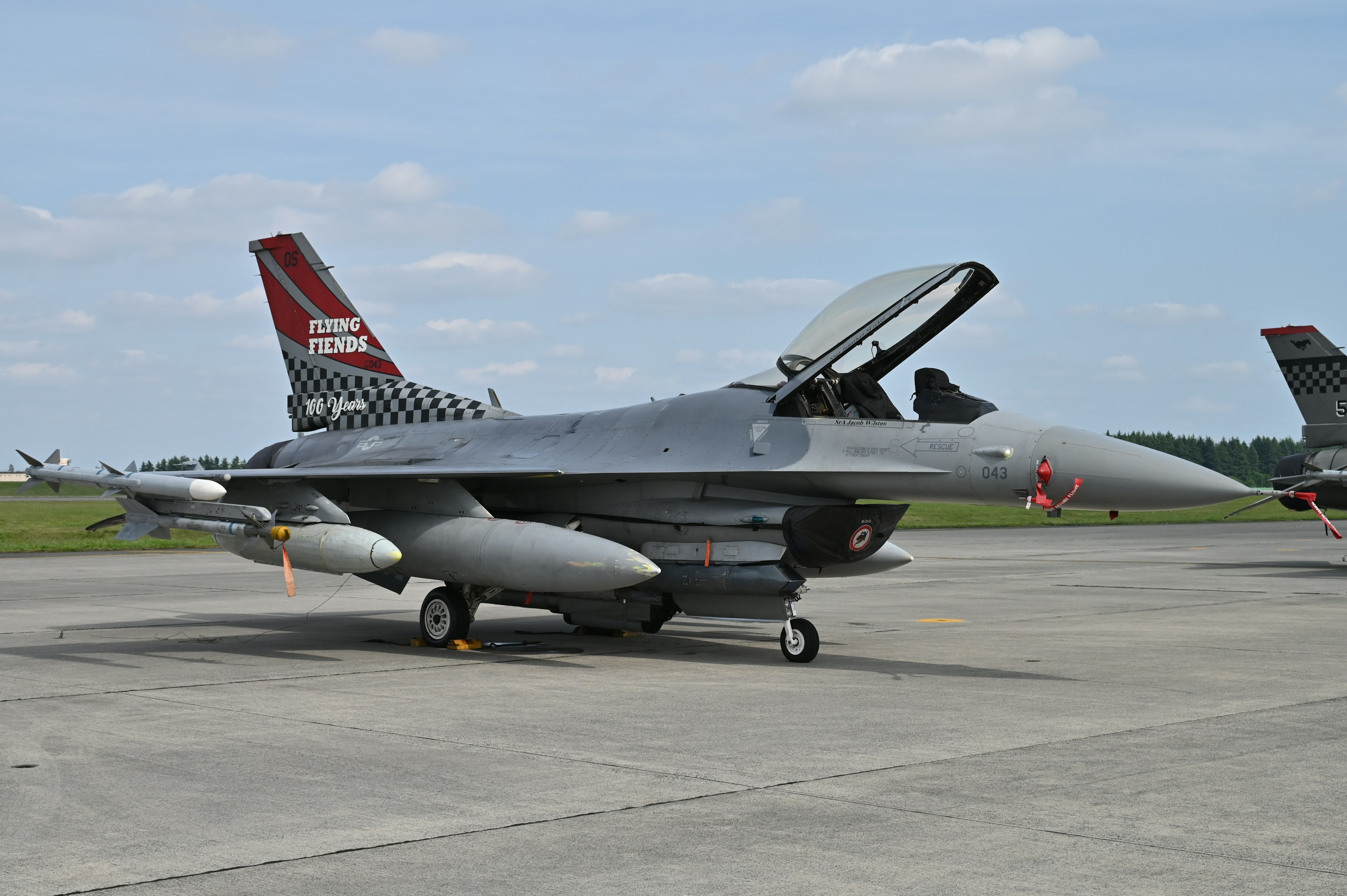 F-16 fighter jet on runway with the canopy open