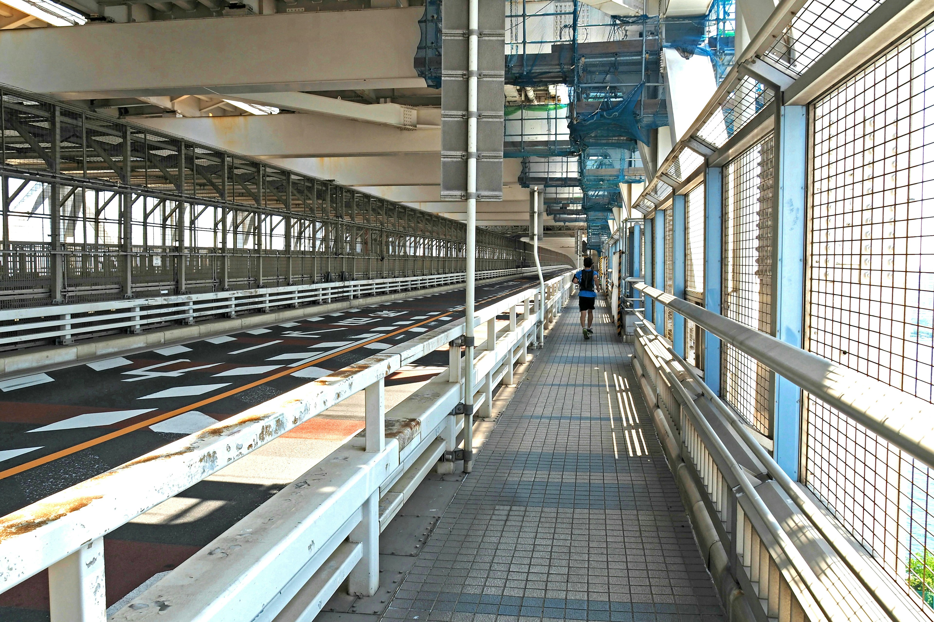 Bright industrial space with a wide walkway and metal railings