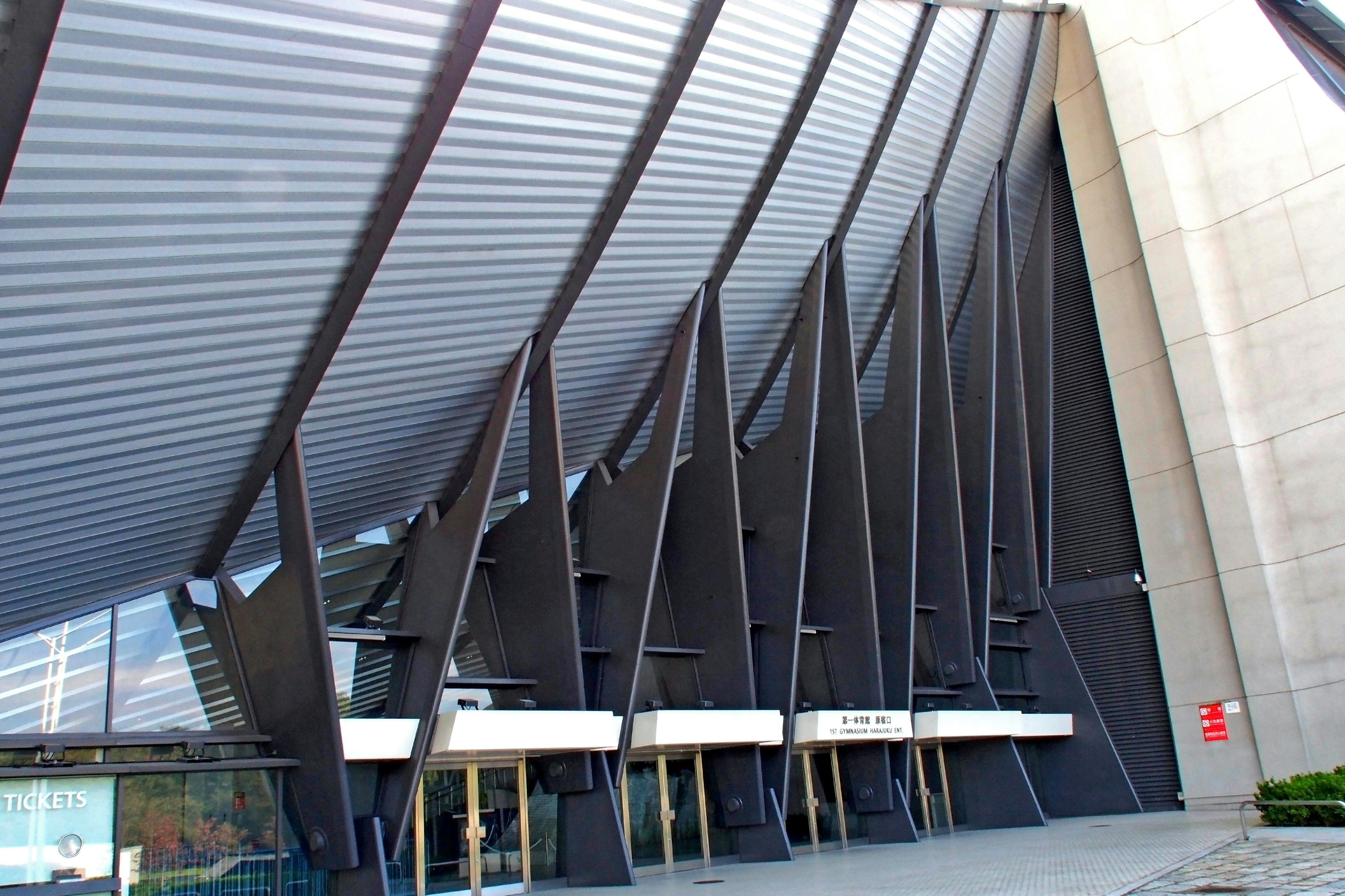 Modern building exterior with angled roof and distinctive columns