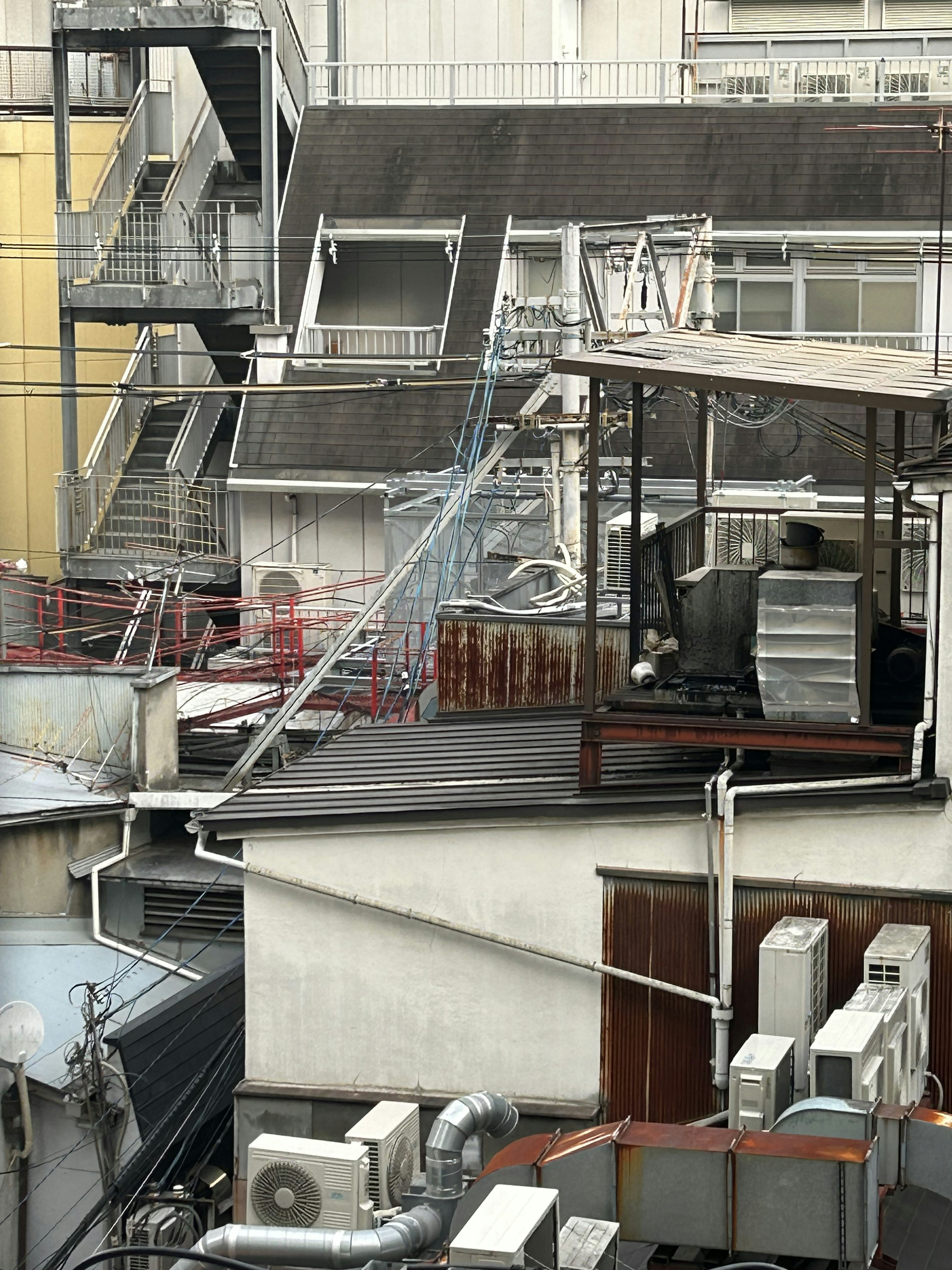 Urban rooftop view featuring stairs and structures