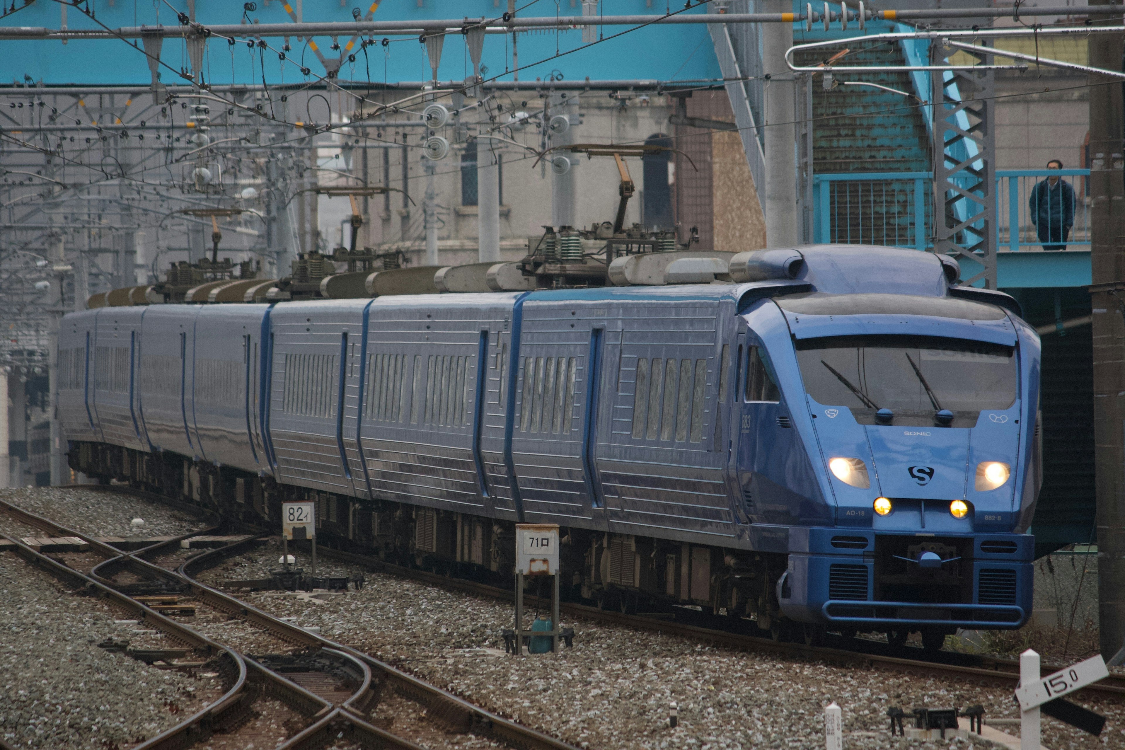 青い電車が線路を走る風景