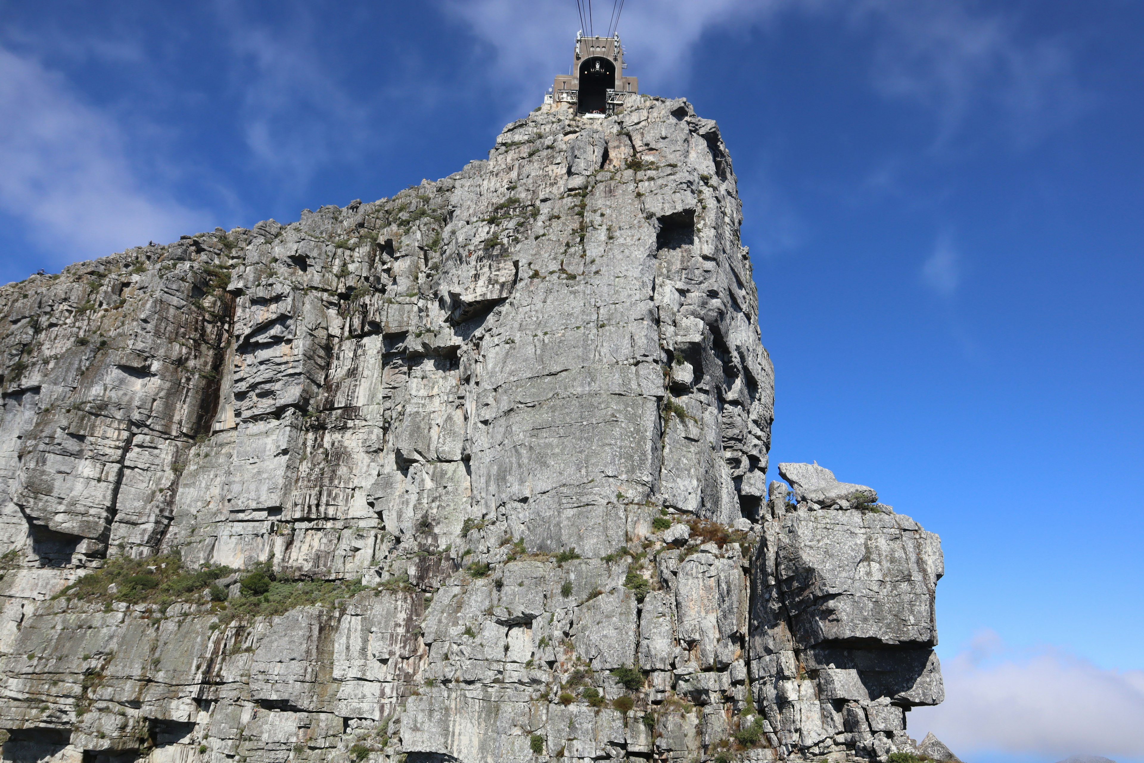 Tall rocky cliff with a clear blue sky