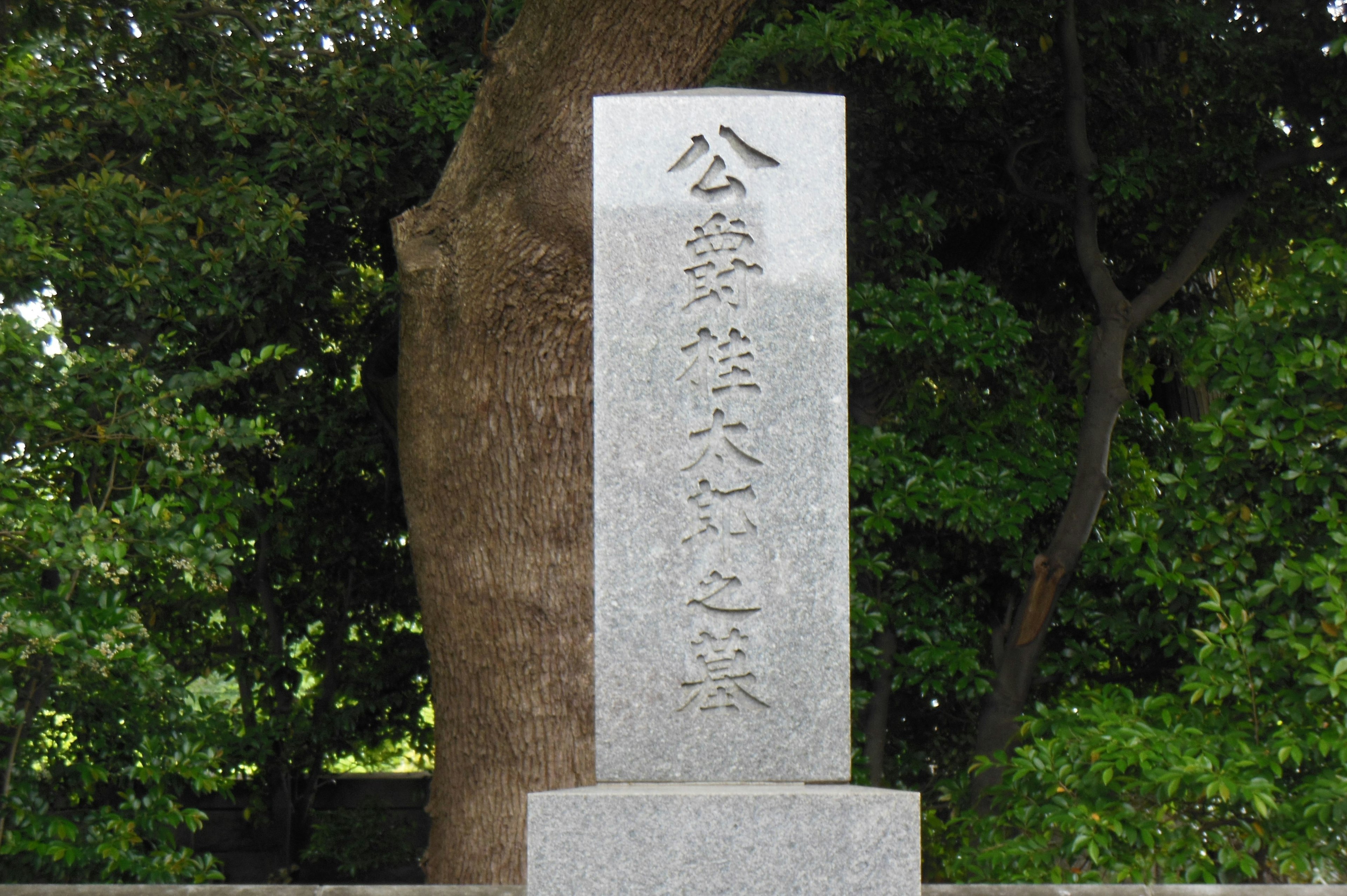 Monumento de piedra en un parque rodeado de vegetación exuberante