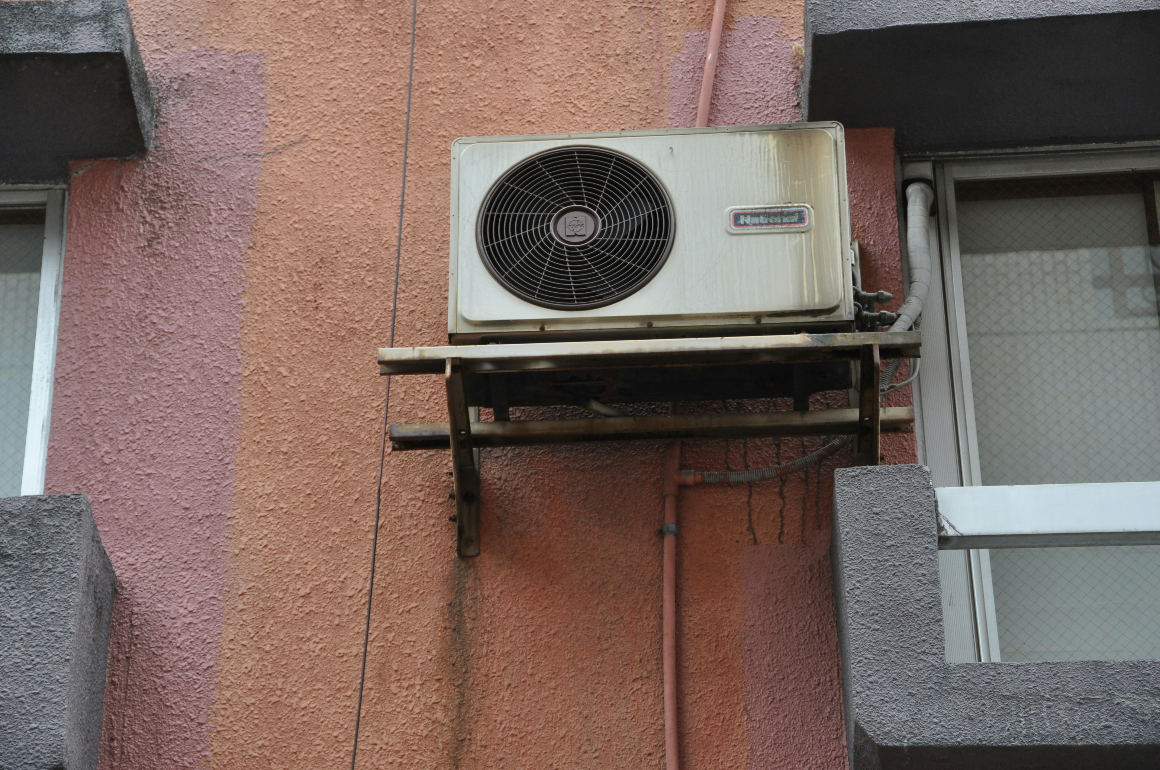 Air conditioning unit mounted on a building wall