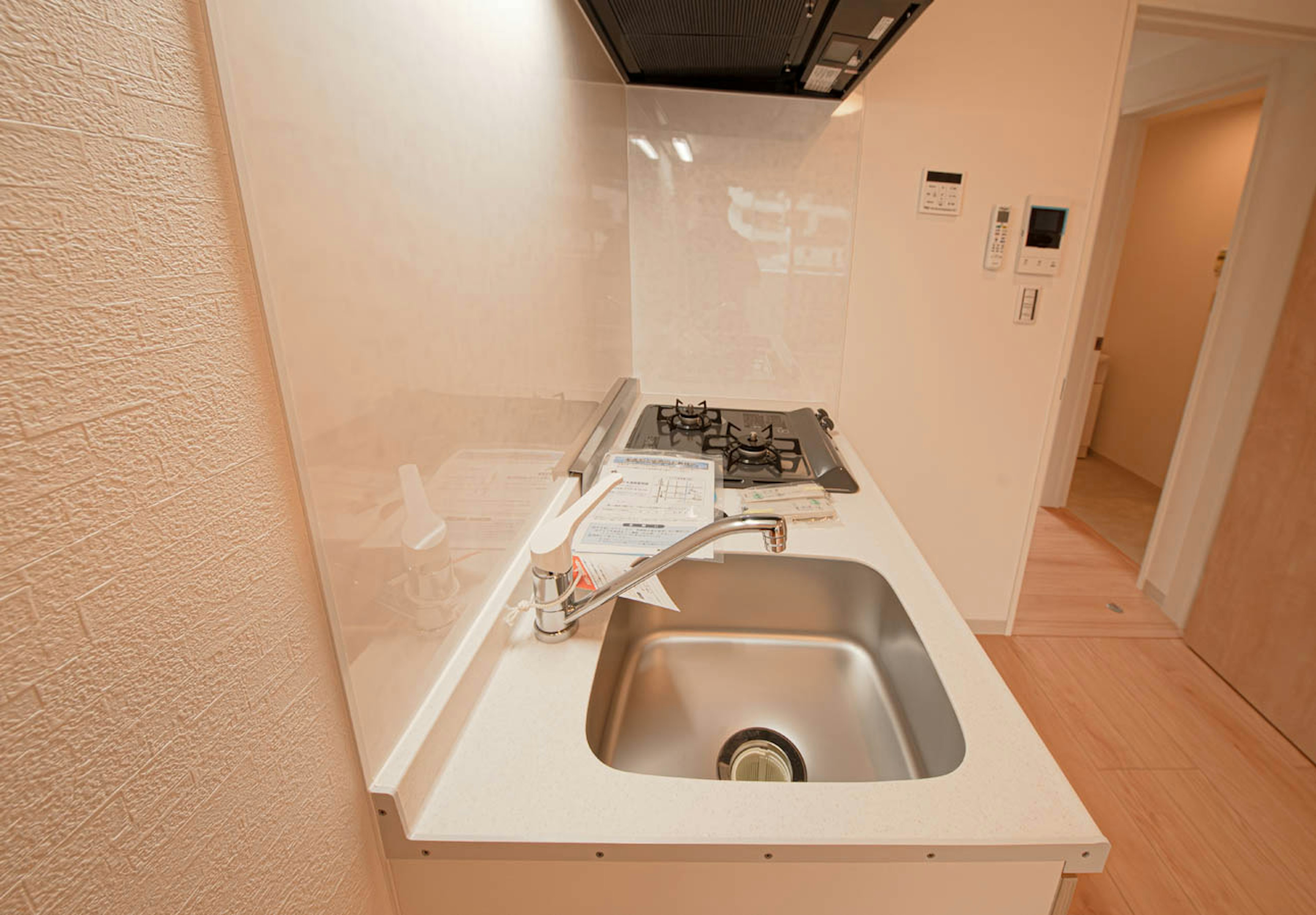 A modern kitchen corner featuring a sink and a gas stove