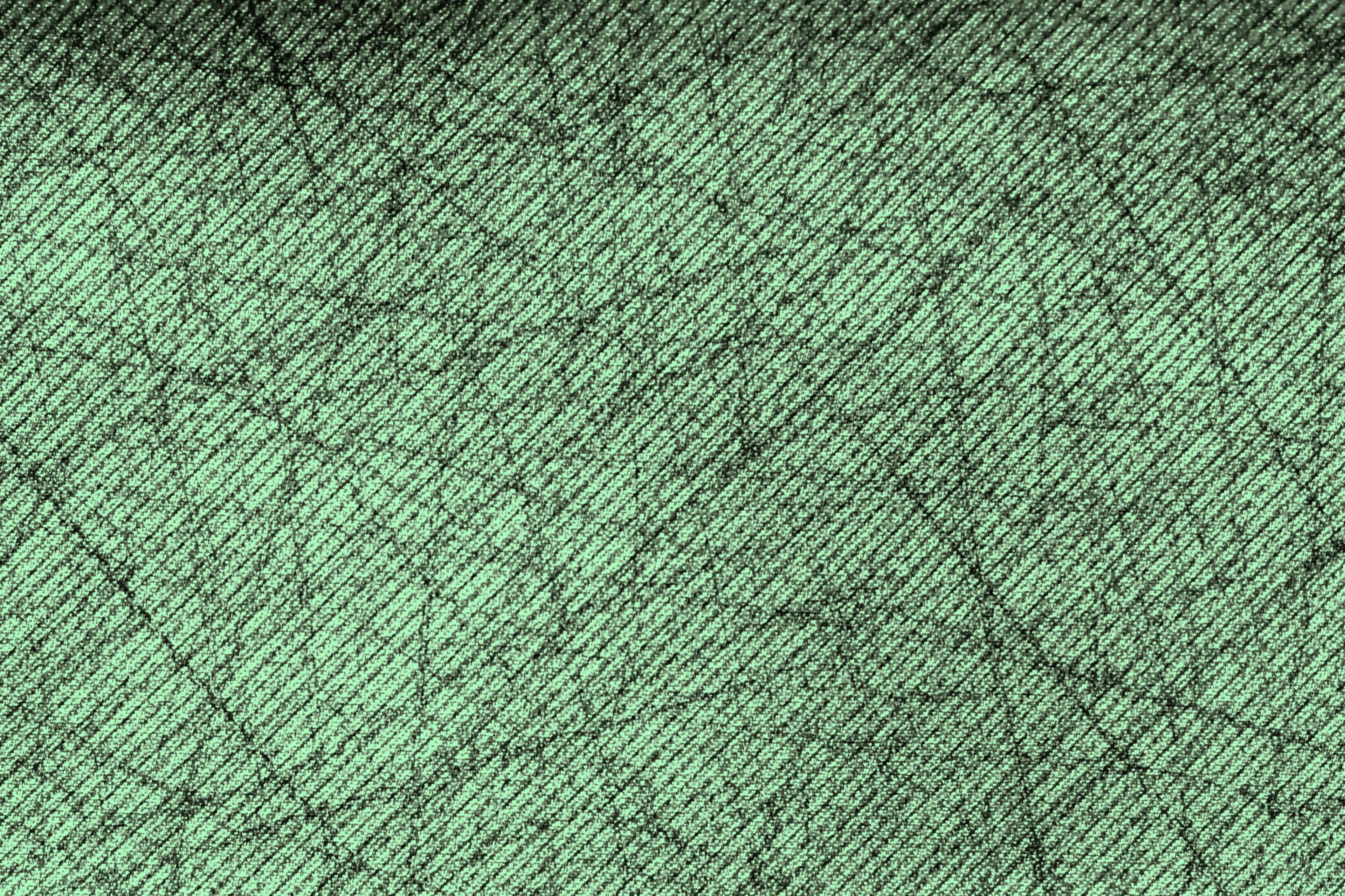 Textured surface with a green hue and thin black lines intersecting