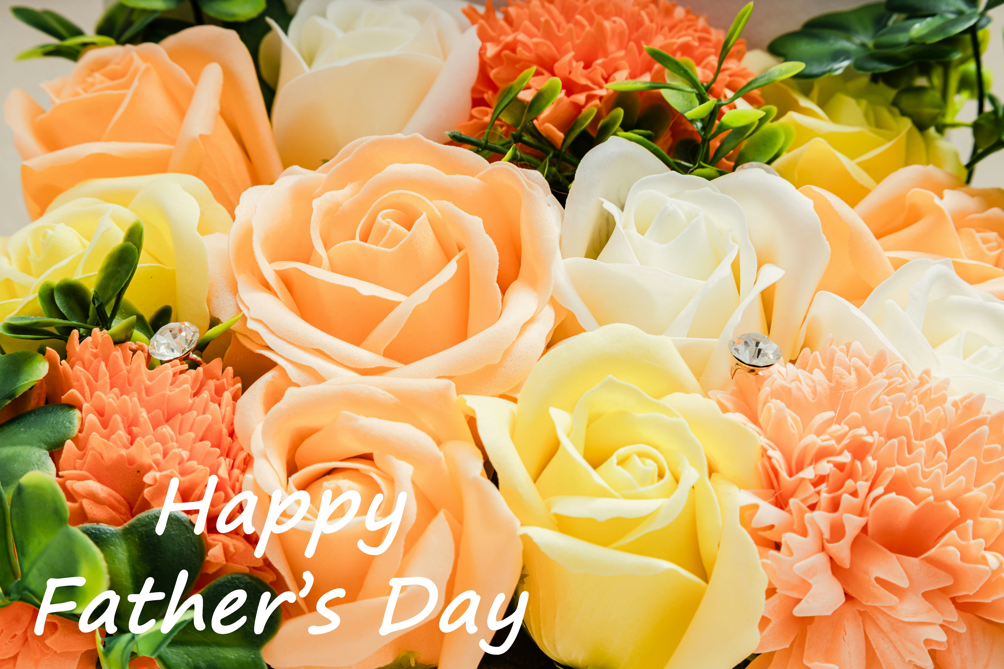 Bouquet of orange and cream roses with carnations celebrating Father's Day