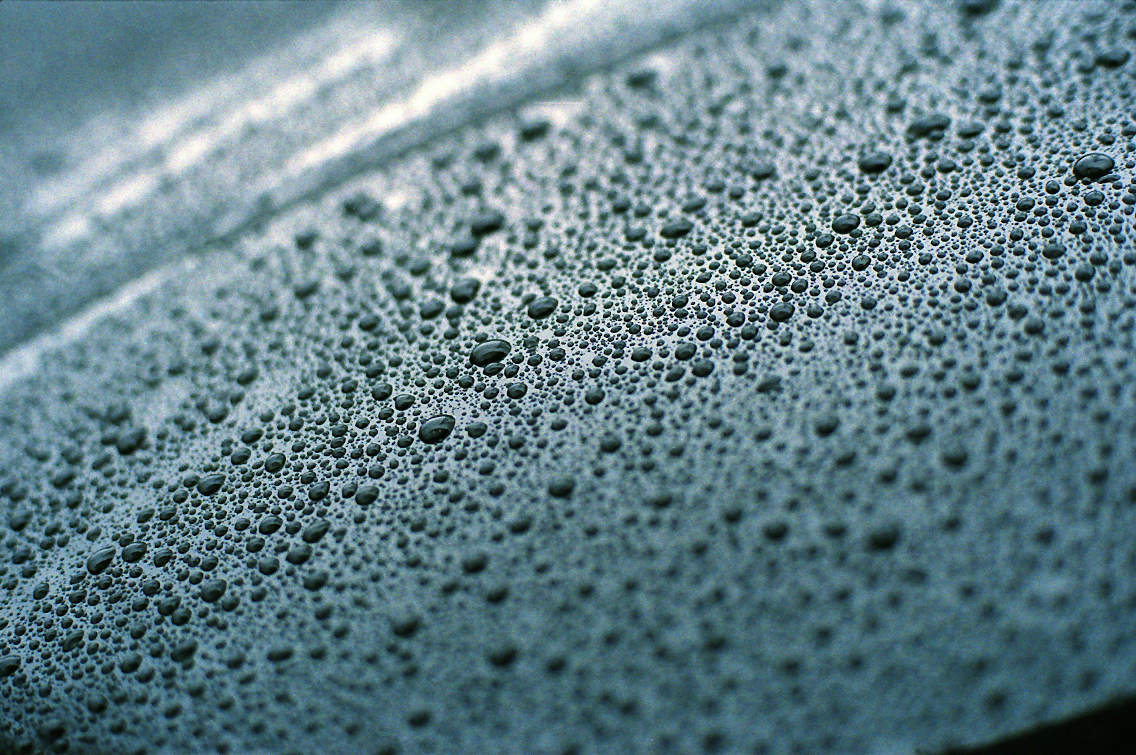 Close-up of water droplets on a metallic surface