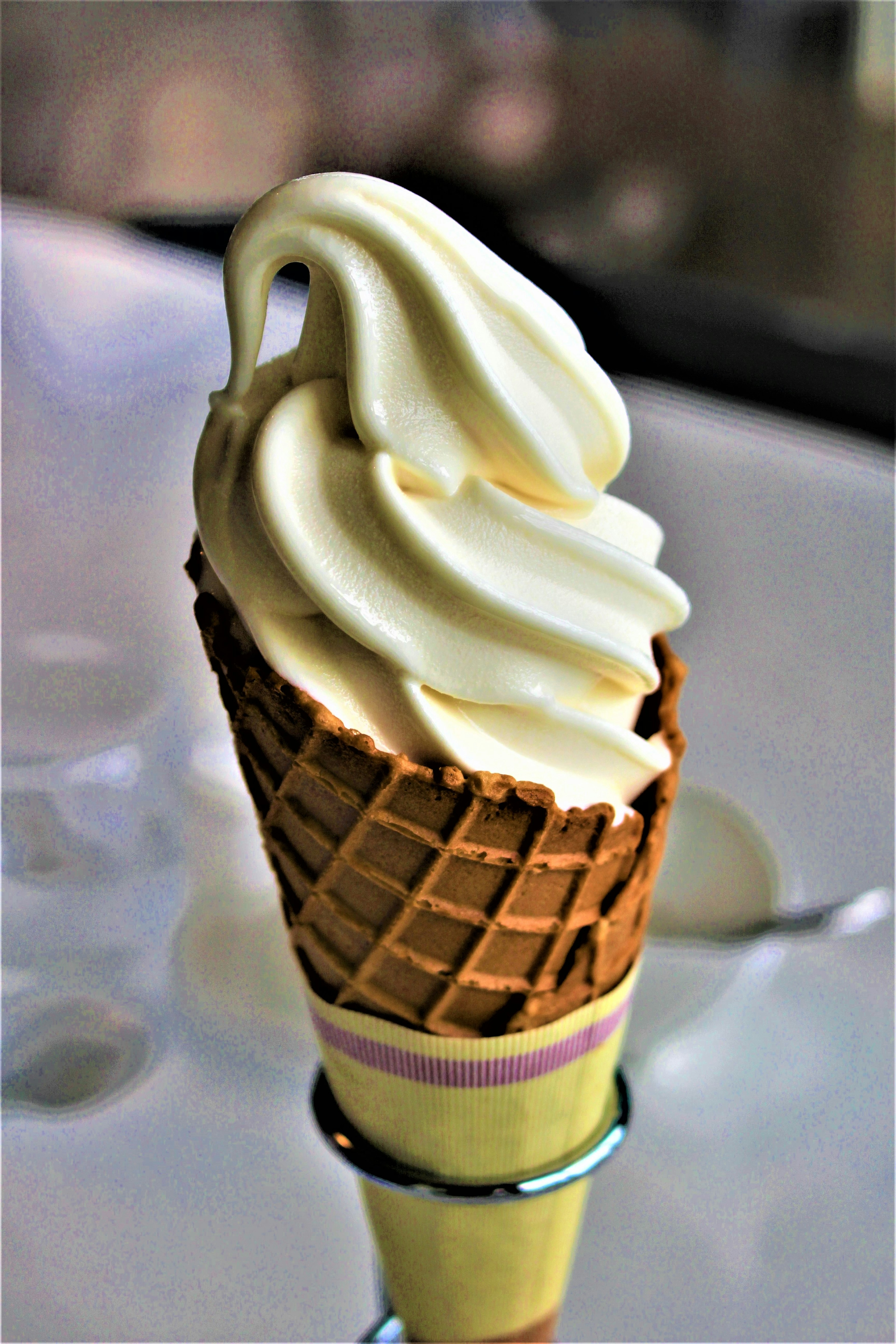 Creamy soft serve ice cream in a waffle cone