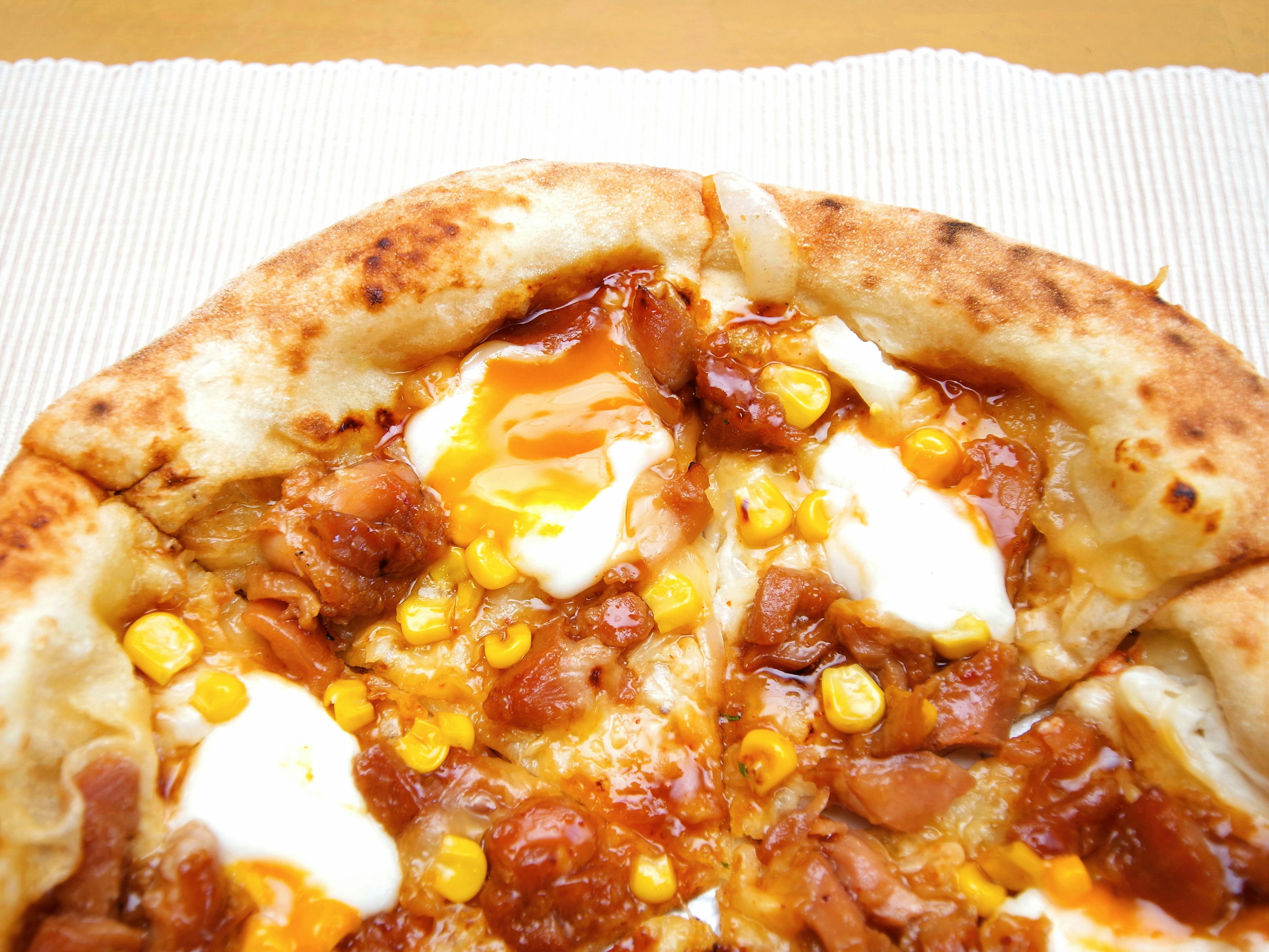 Close-up of pizza topped with corn and egg