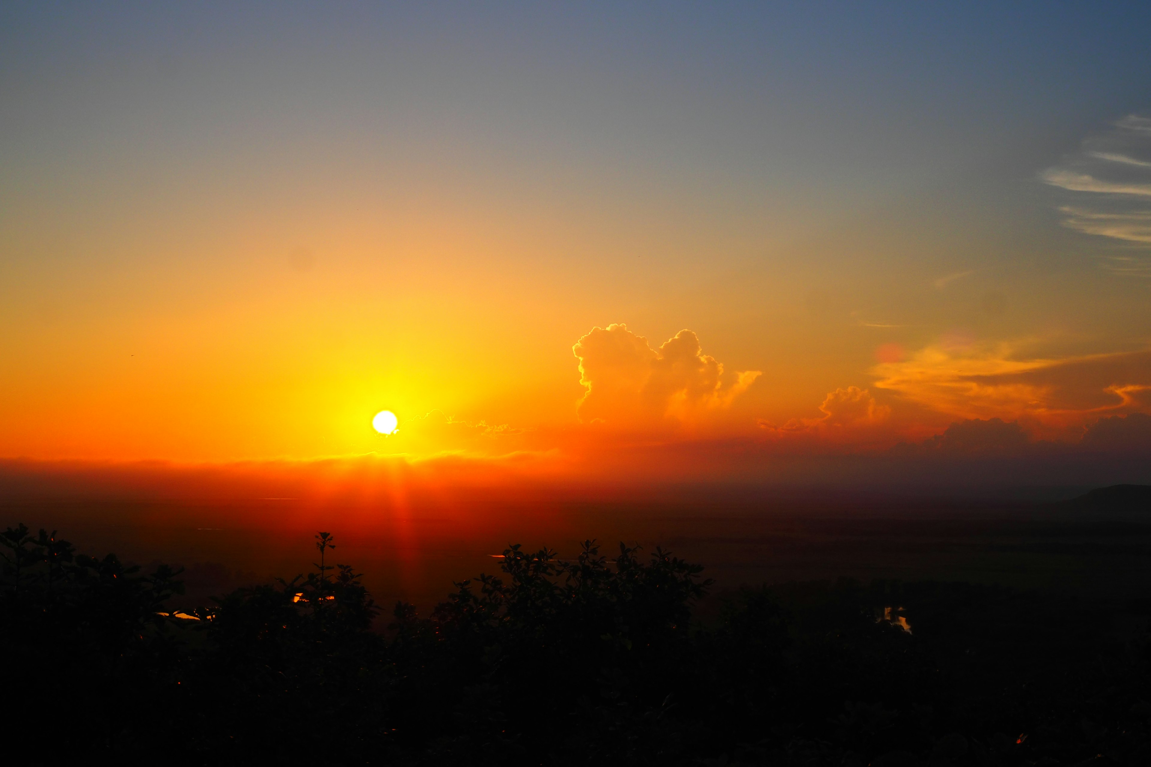 Stunning sunrise with orange sky and distant mountains