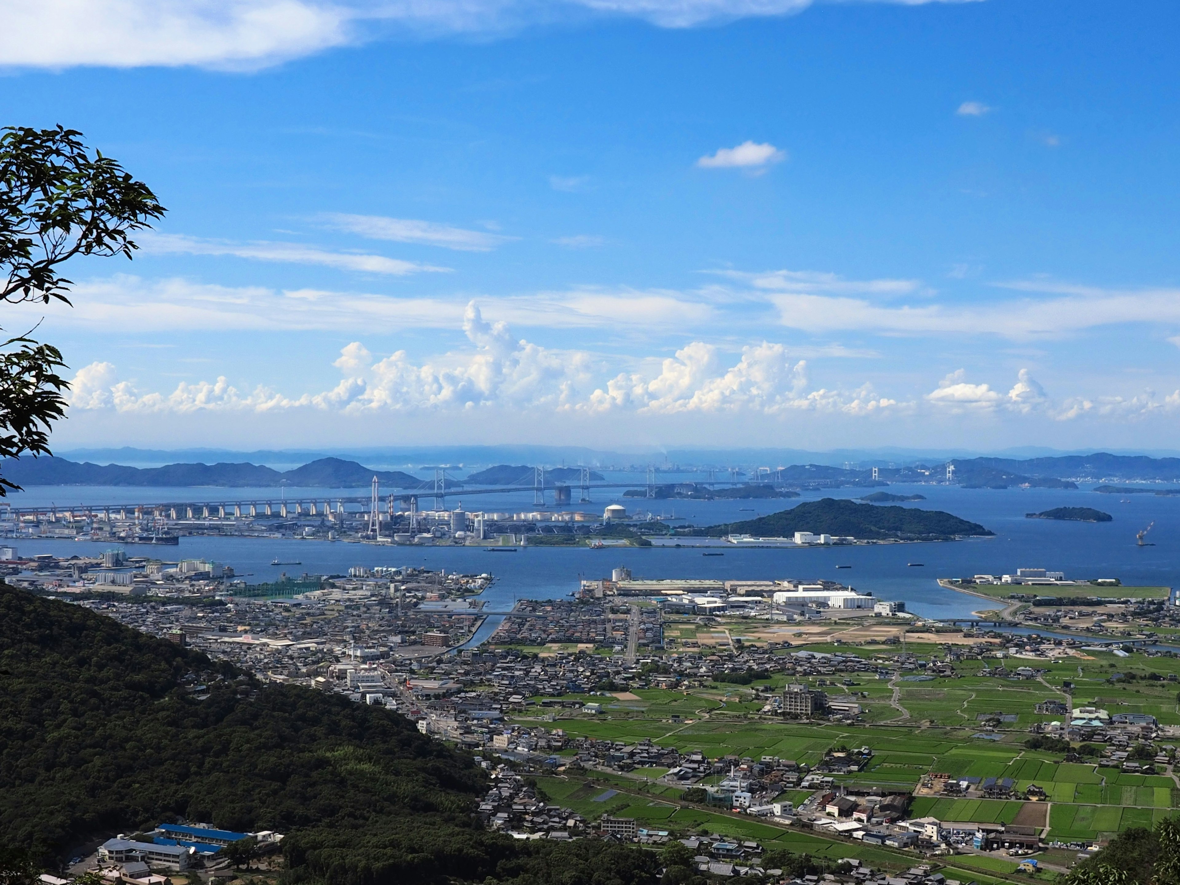 Scenic view featuring blue sky and white clouds bridges and surrounding sea