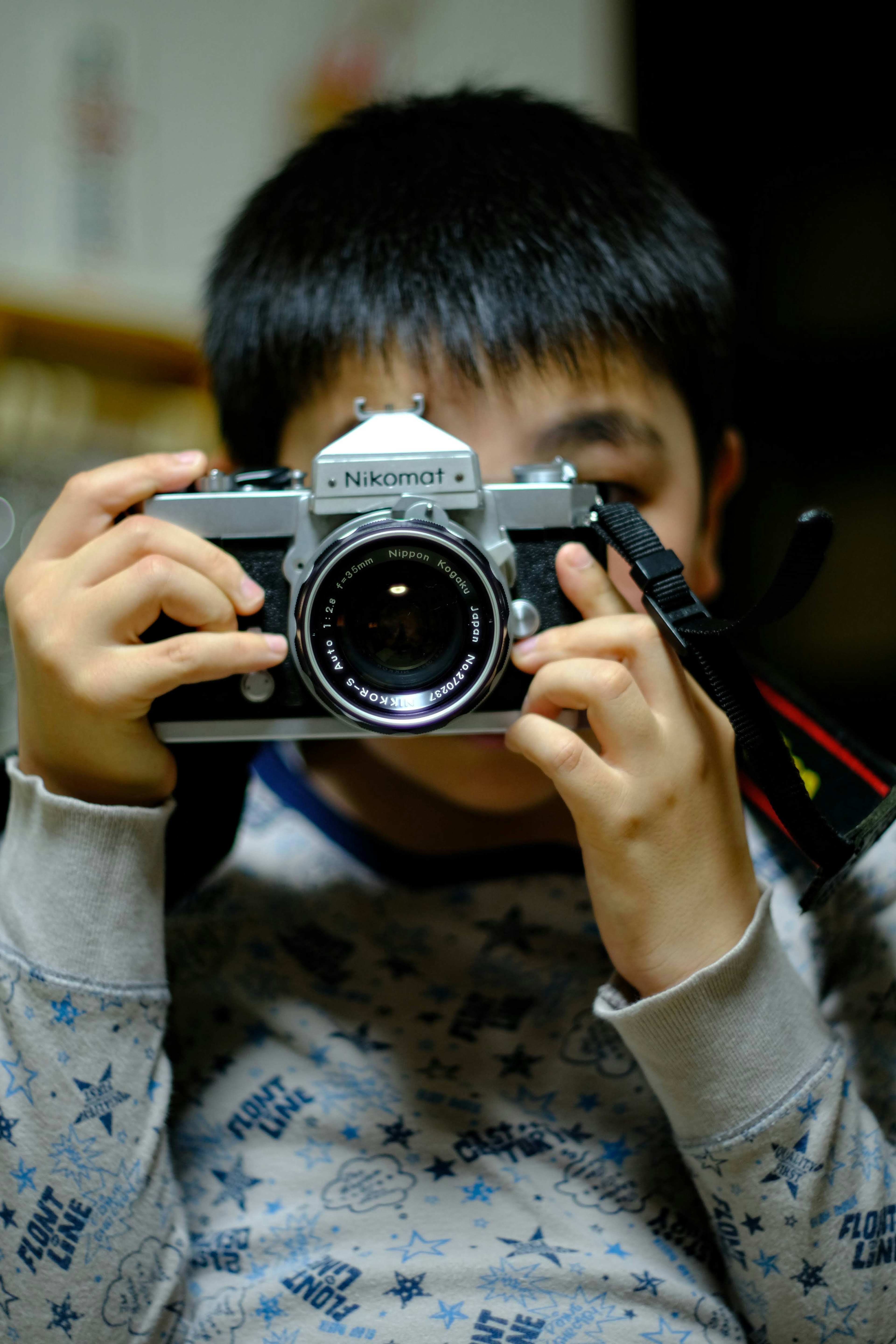 Portrait of a boy holding a camera