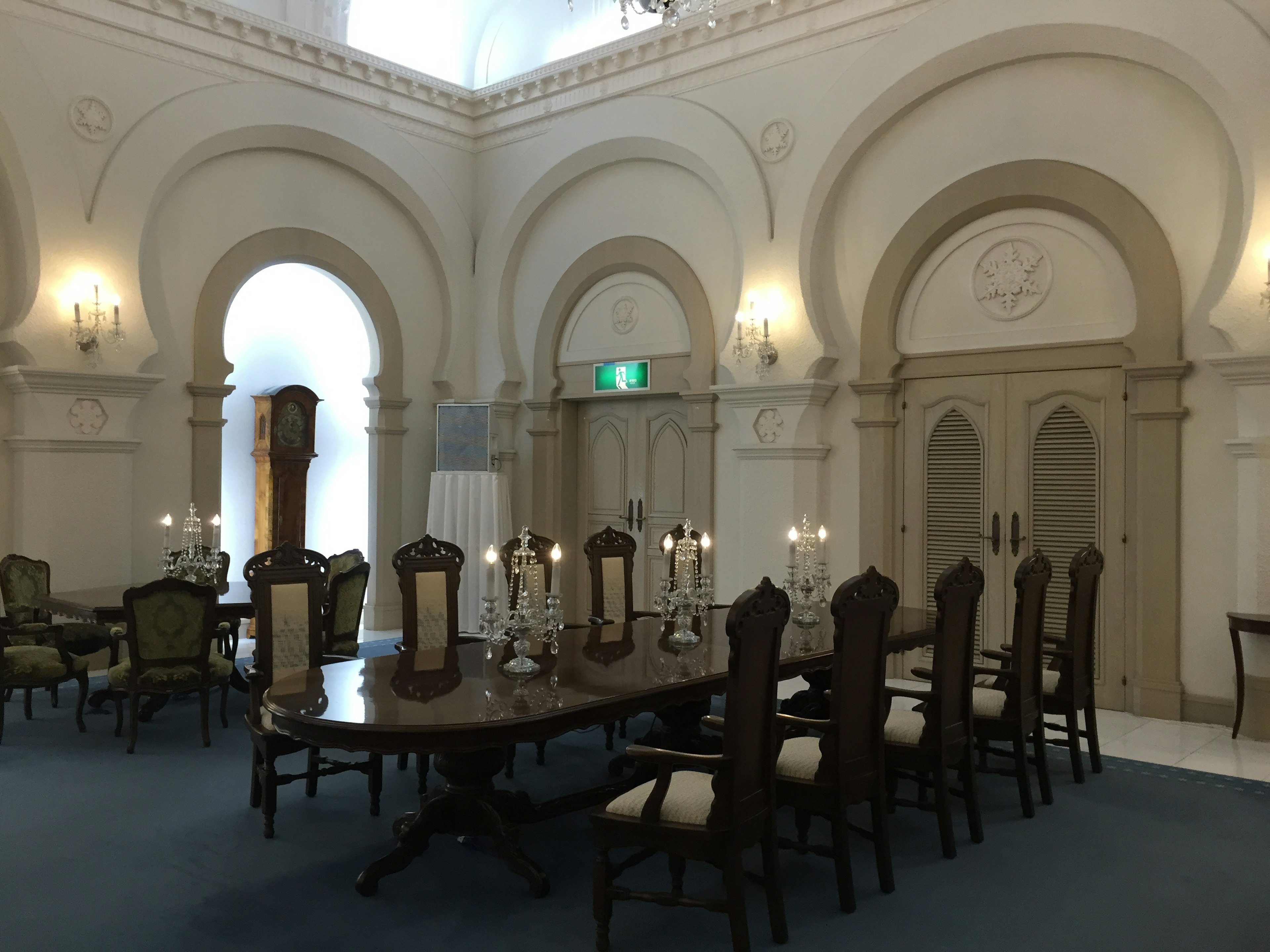 Elegant dining room featuring a large wooden table with chairs and ornate decor