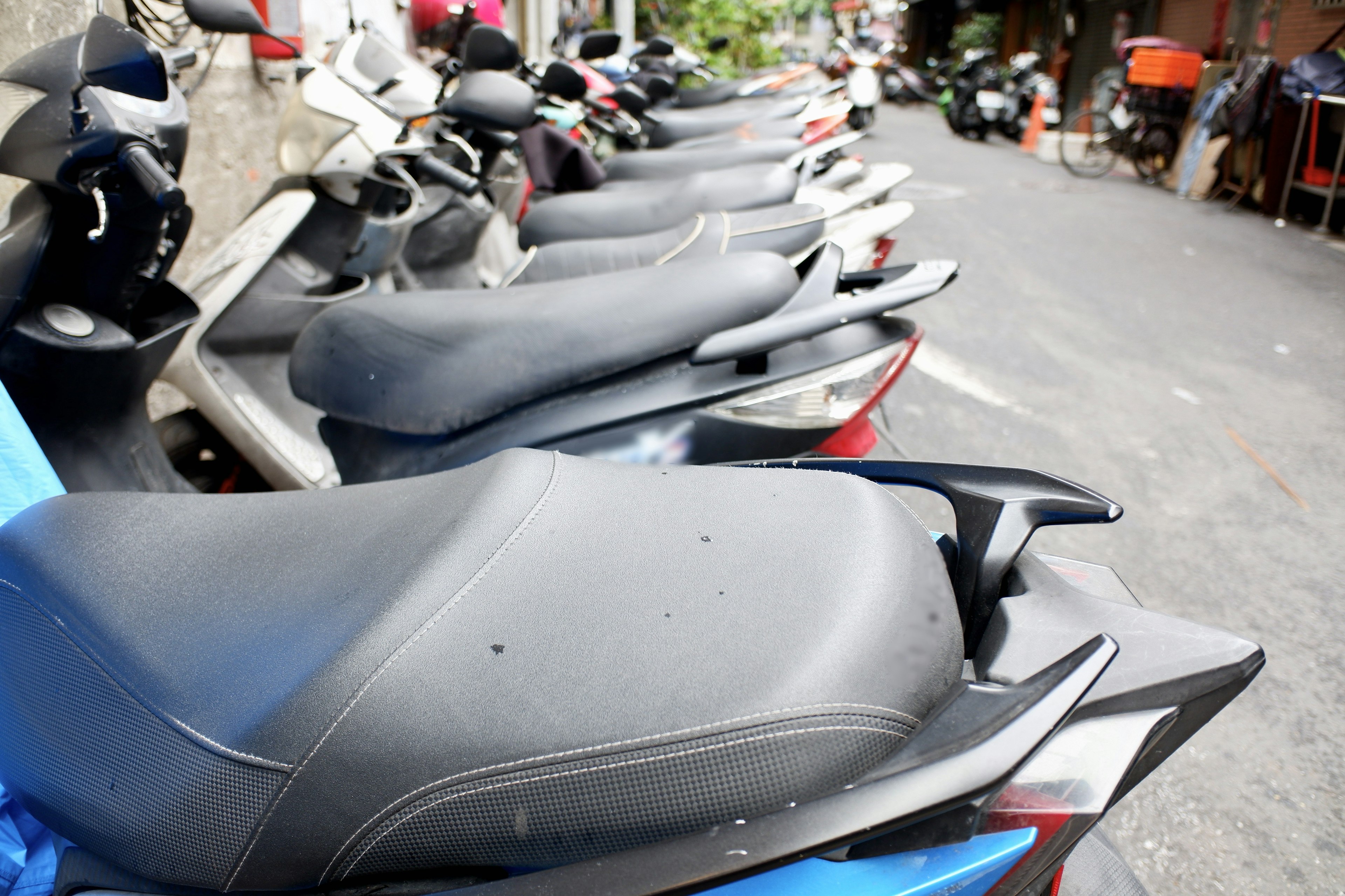 Row of motorcycle seats parked on the street