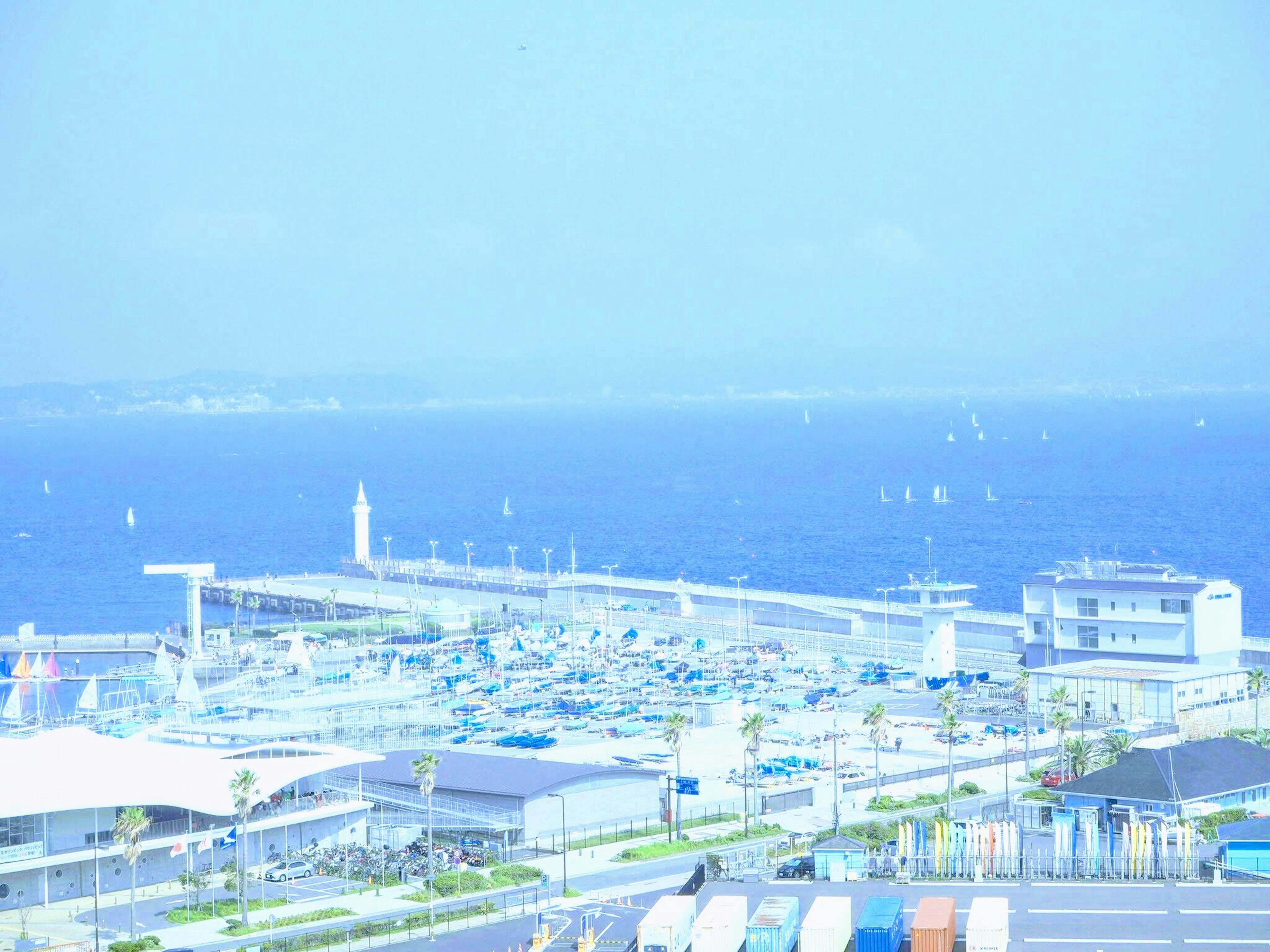 Scenic view of a harbor with blue ocean and buildings visible