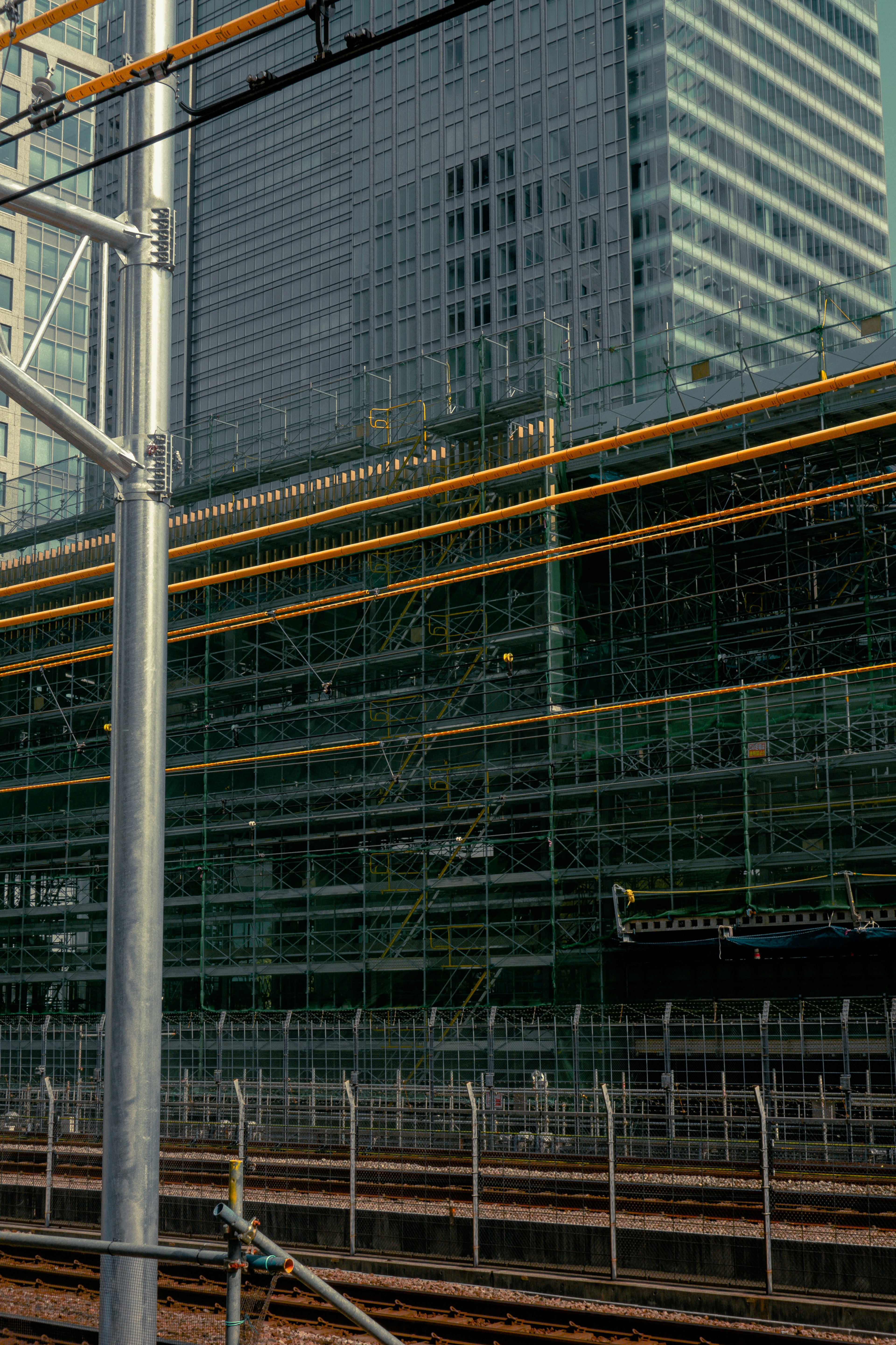 Urban landscape featuring reflections of skyscrapers and railway tracks