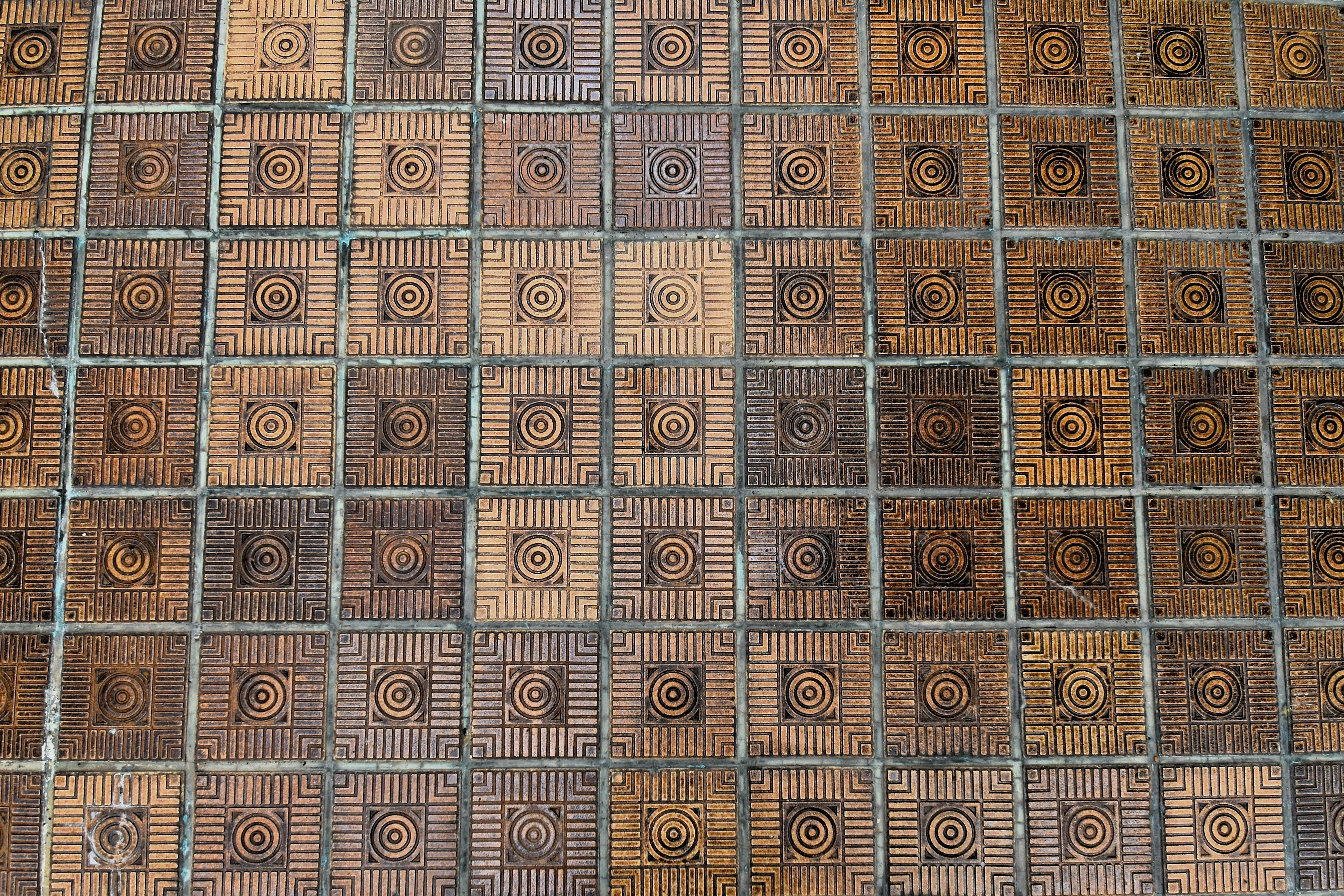 Floor covered with intricate patterned tiles arranged in a grid