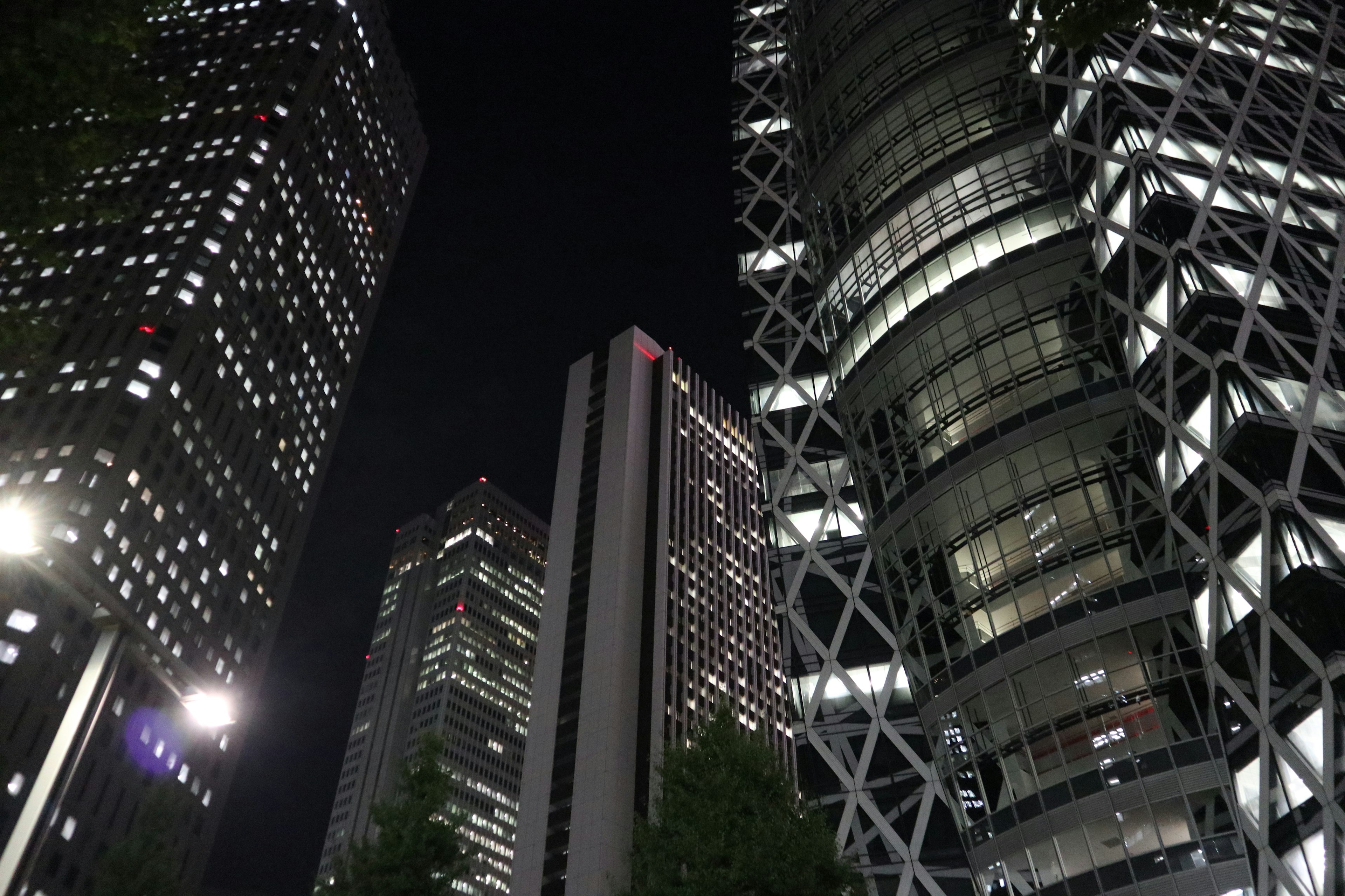 Night cityscape with towering skyscrapers featuring modern architecture