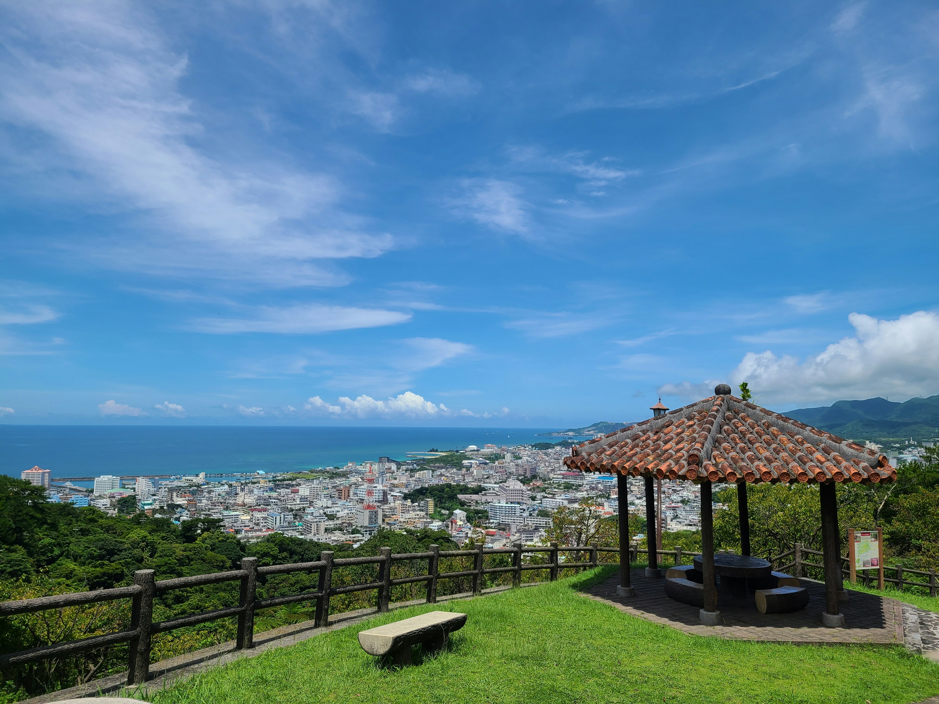 Traditional gazebo on a green hill overlooking a beautiful ocean view