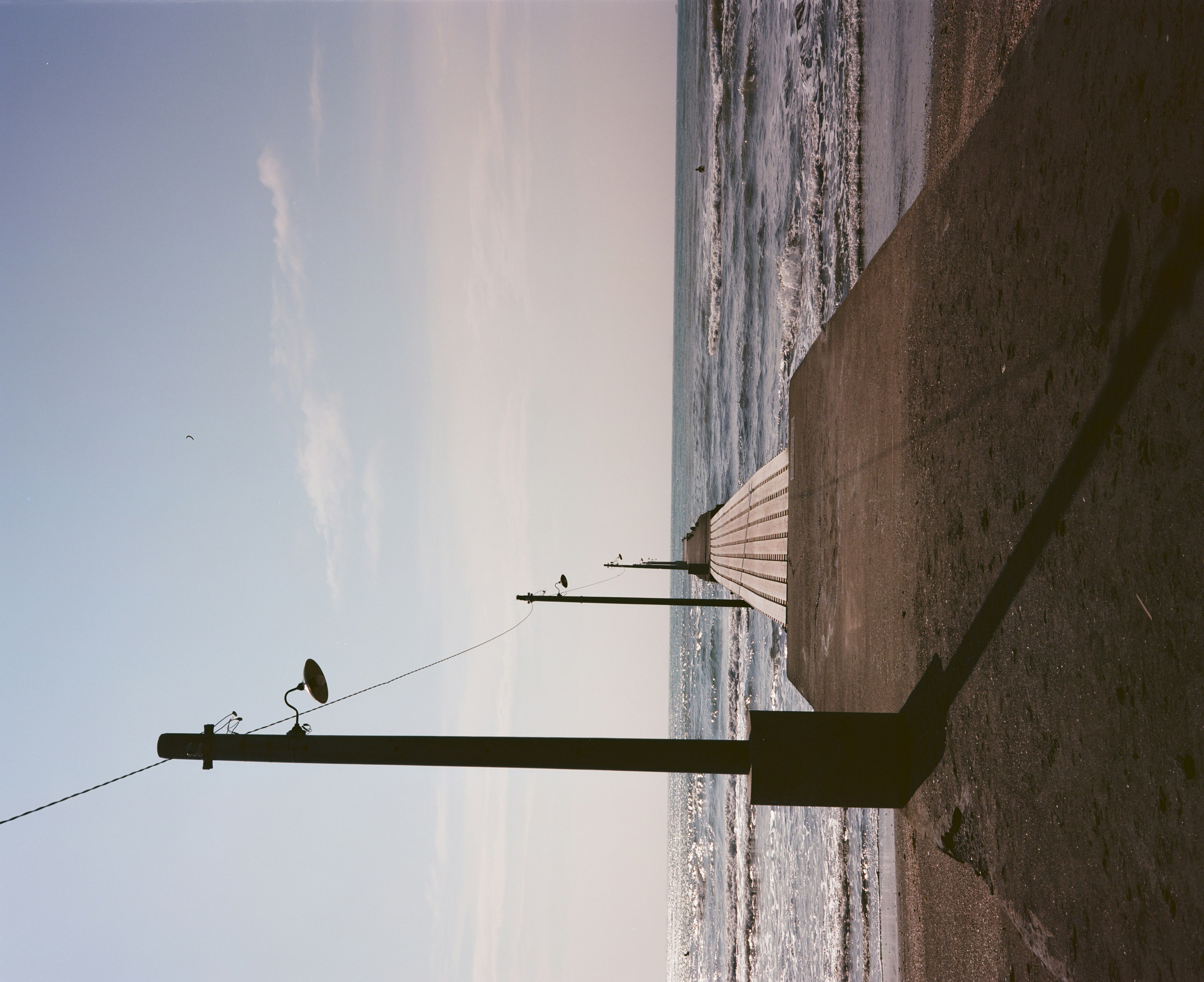 Pier extending into the ocean under a clear sky