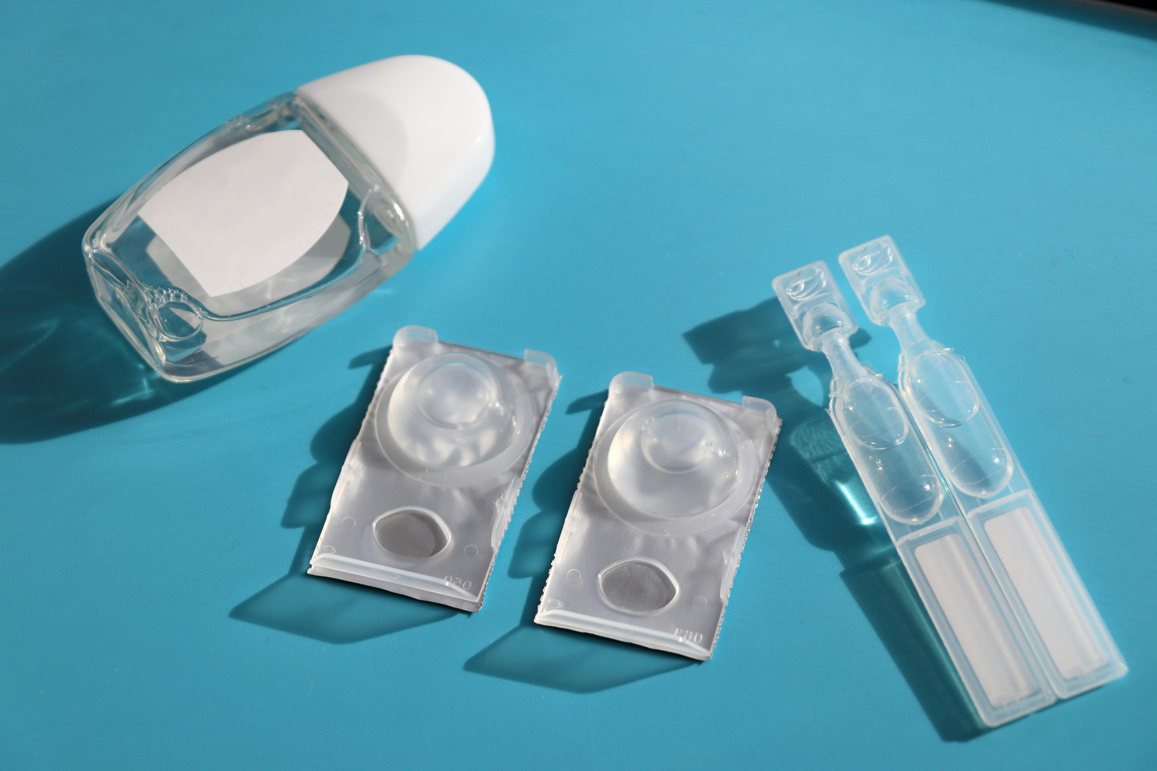 Contact lens case and lenses on a blue background