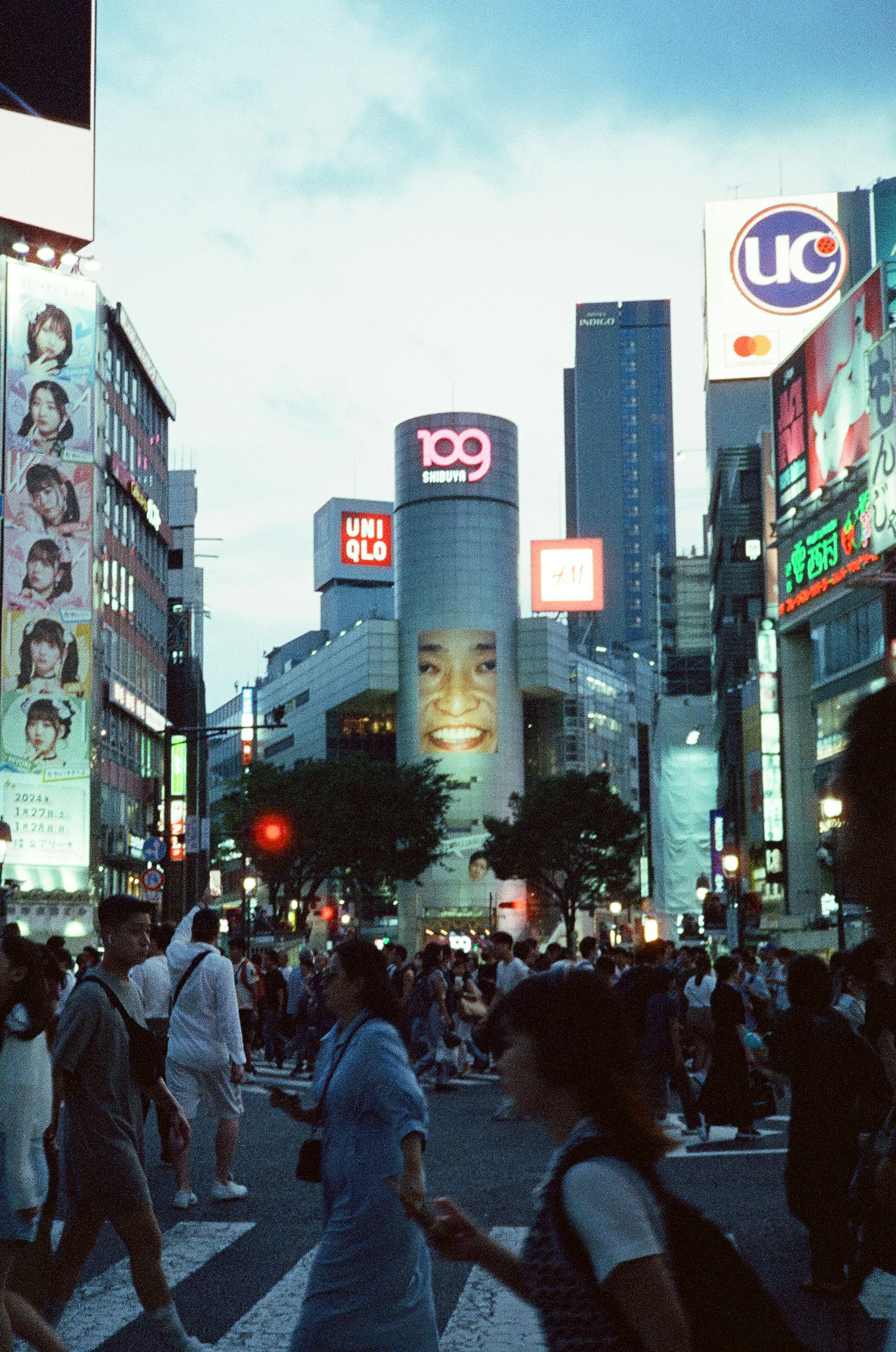 Busy intersection with crowds and skyscrapers in an urban setting