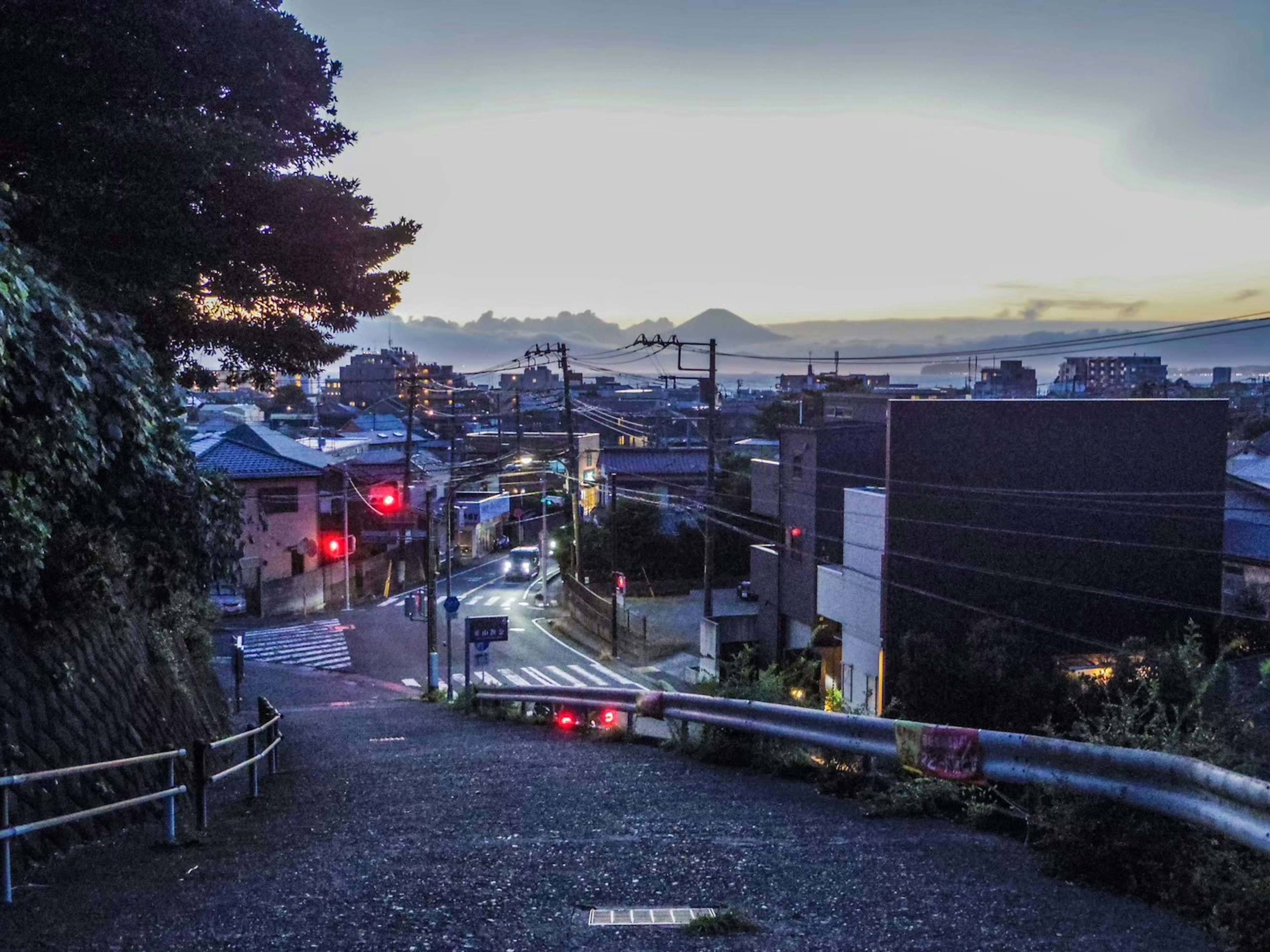 Twilight cityscape with mountains in the background