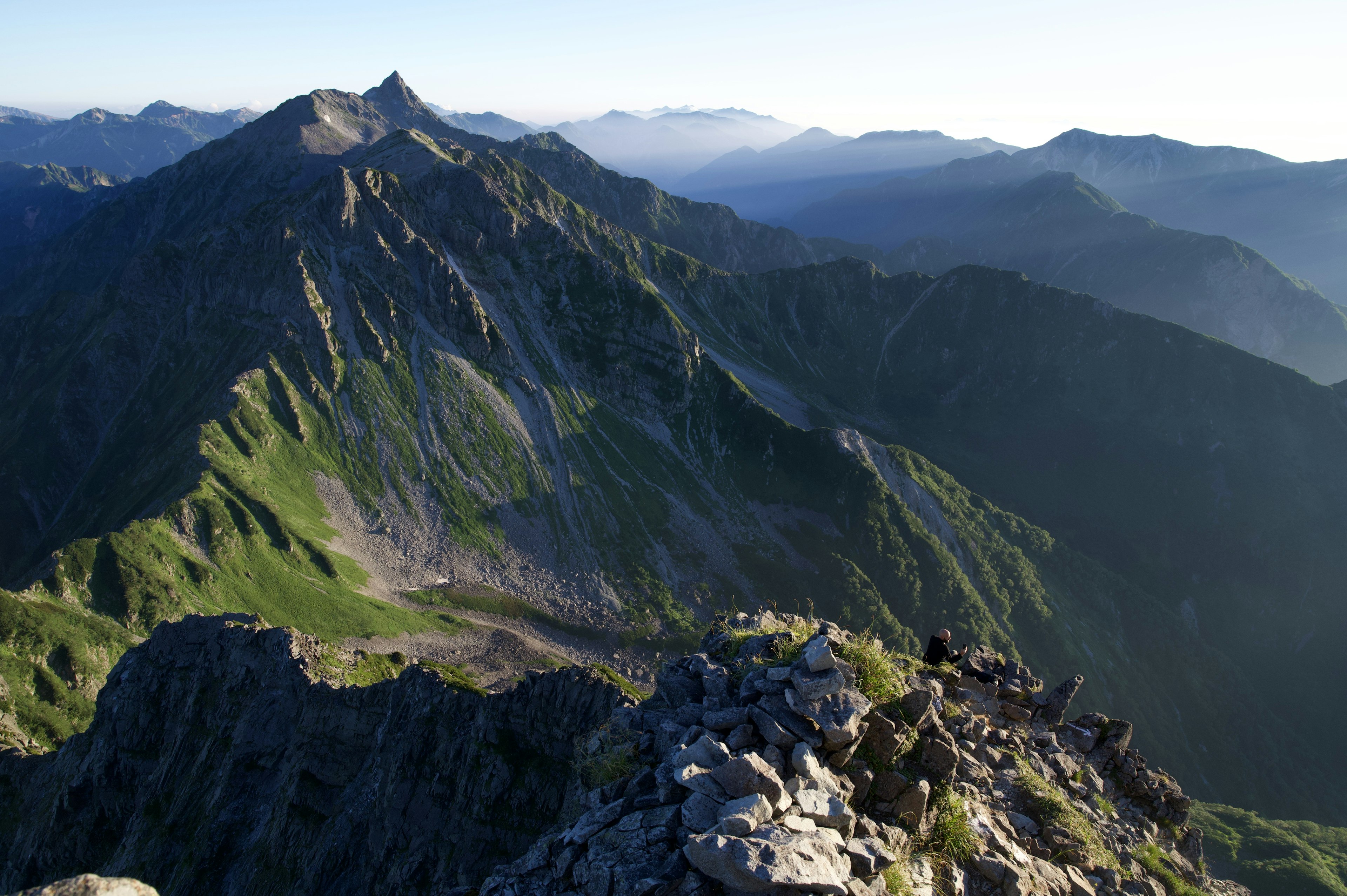 Vista mozzafiato dalla cima della montagna con montagne verdi e cielo blu