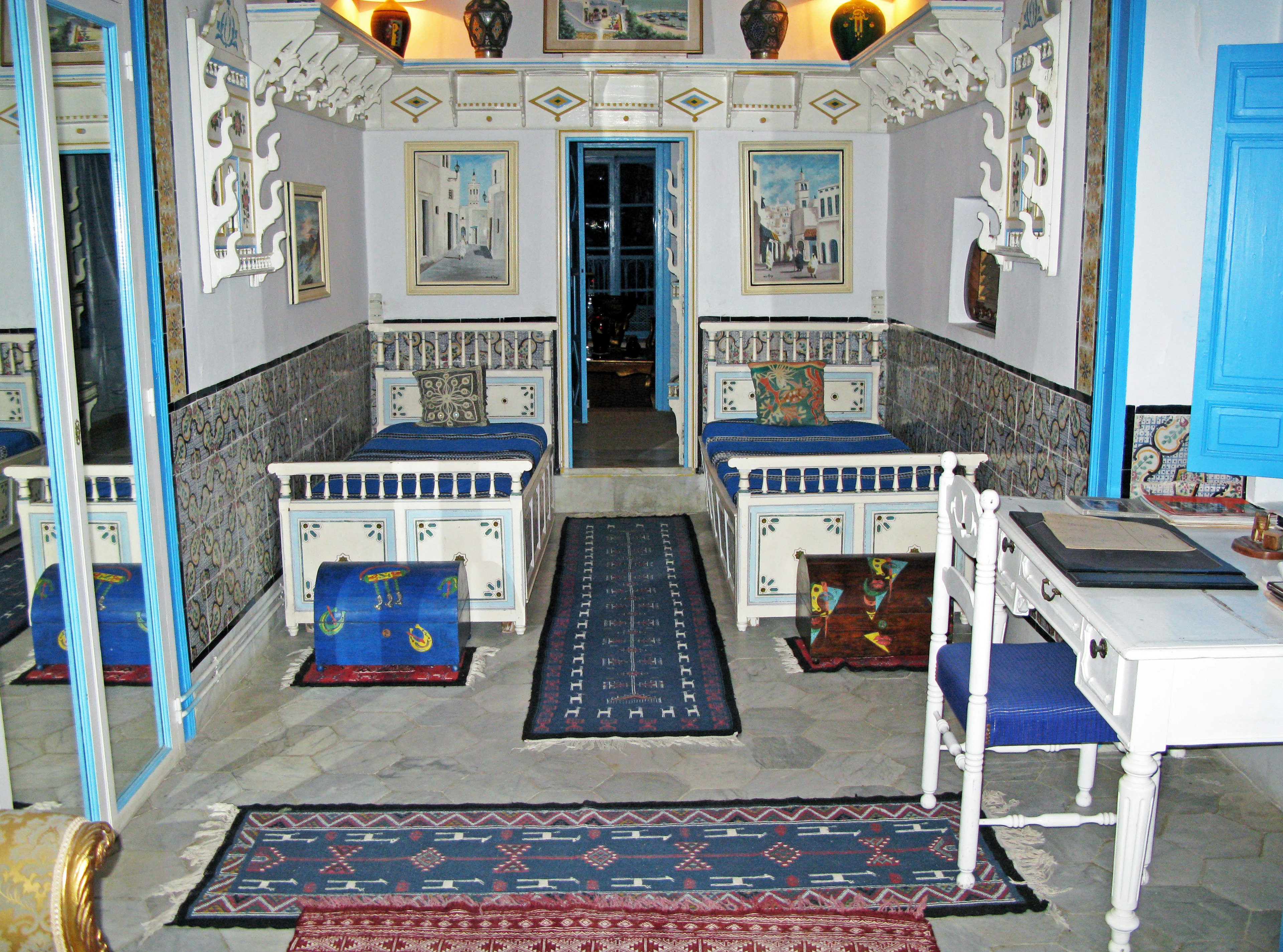 Traditional room with blue door and decorative walls featuring beautiful carpets and furniture