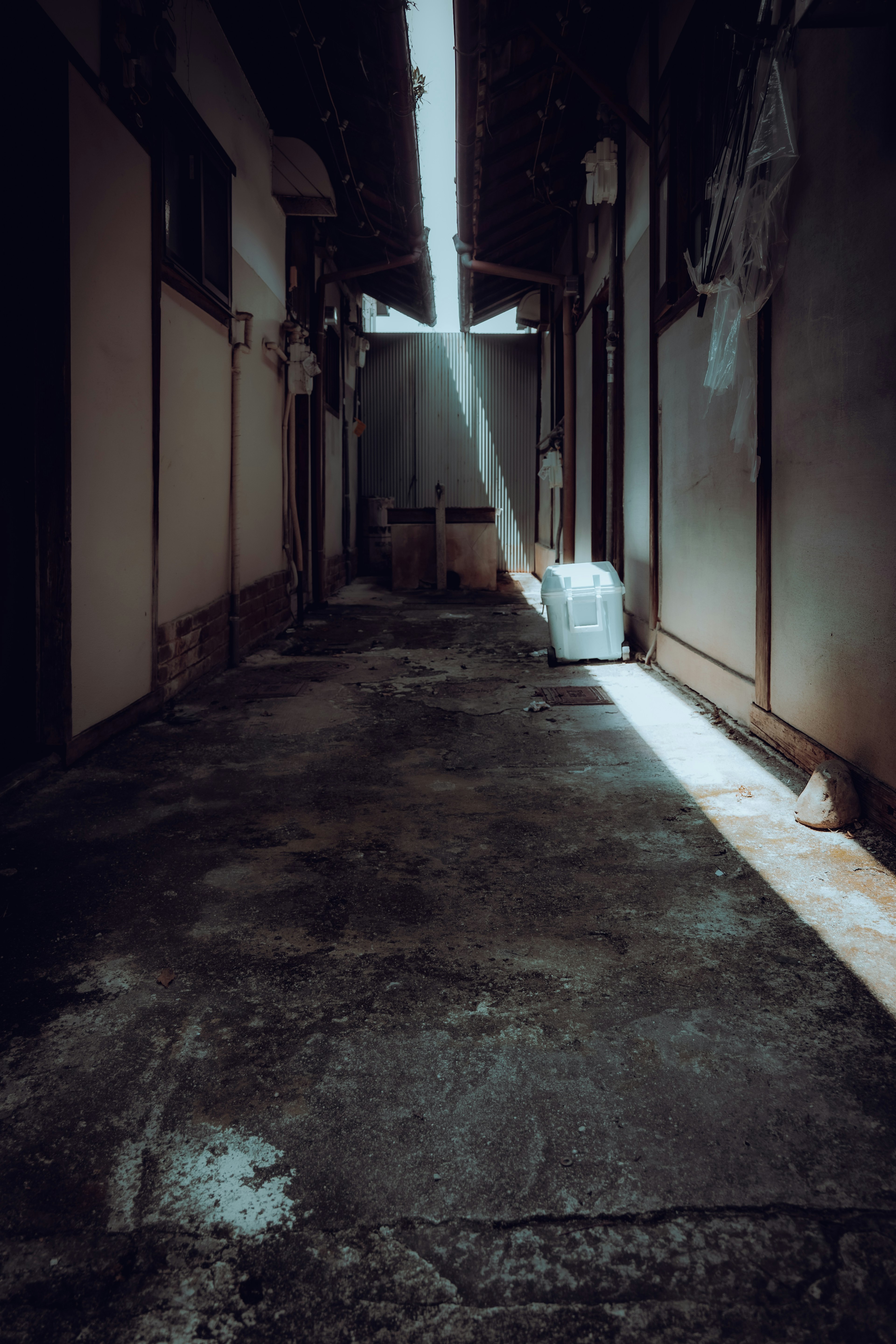 Dimly lit corridor with a beam of light