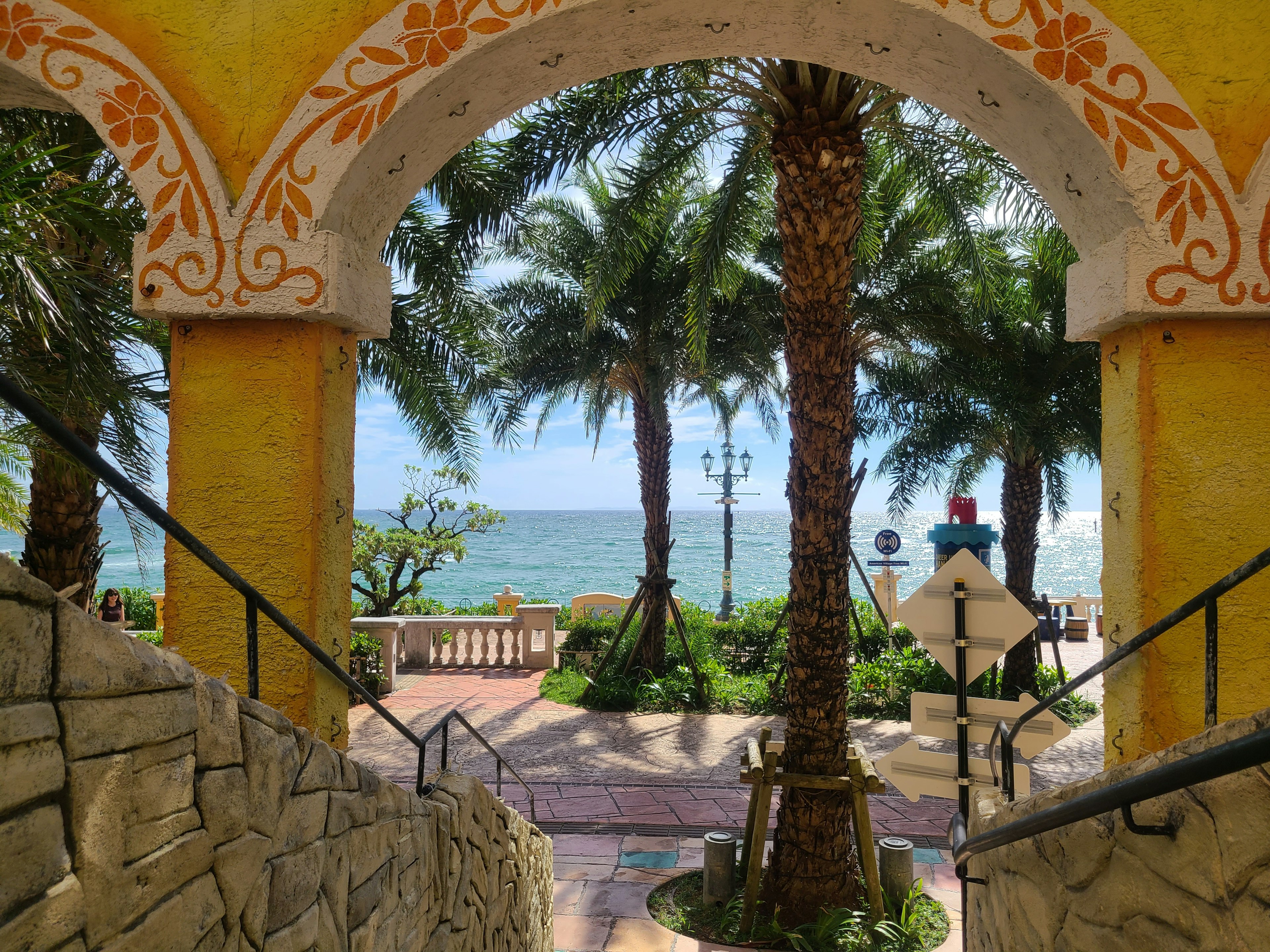 Archway view of the sea with palm trees