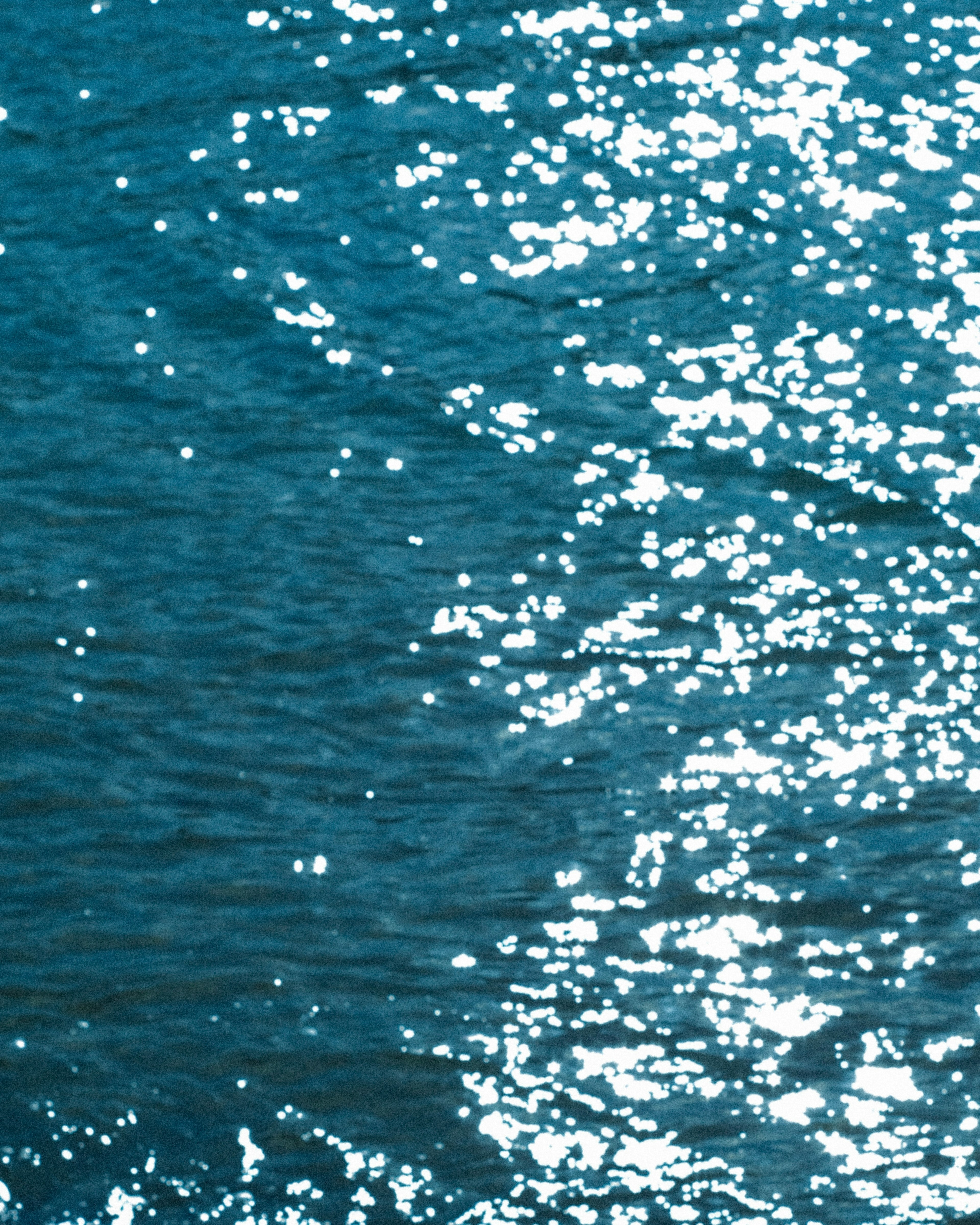 Sunlight reflecting off the surface of blue water