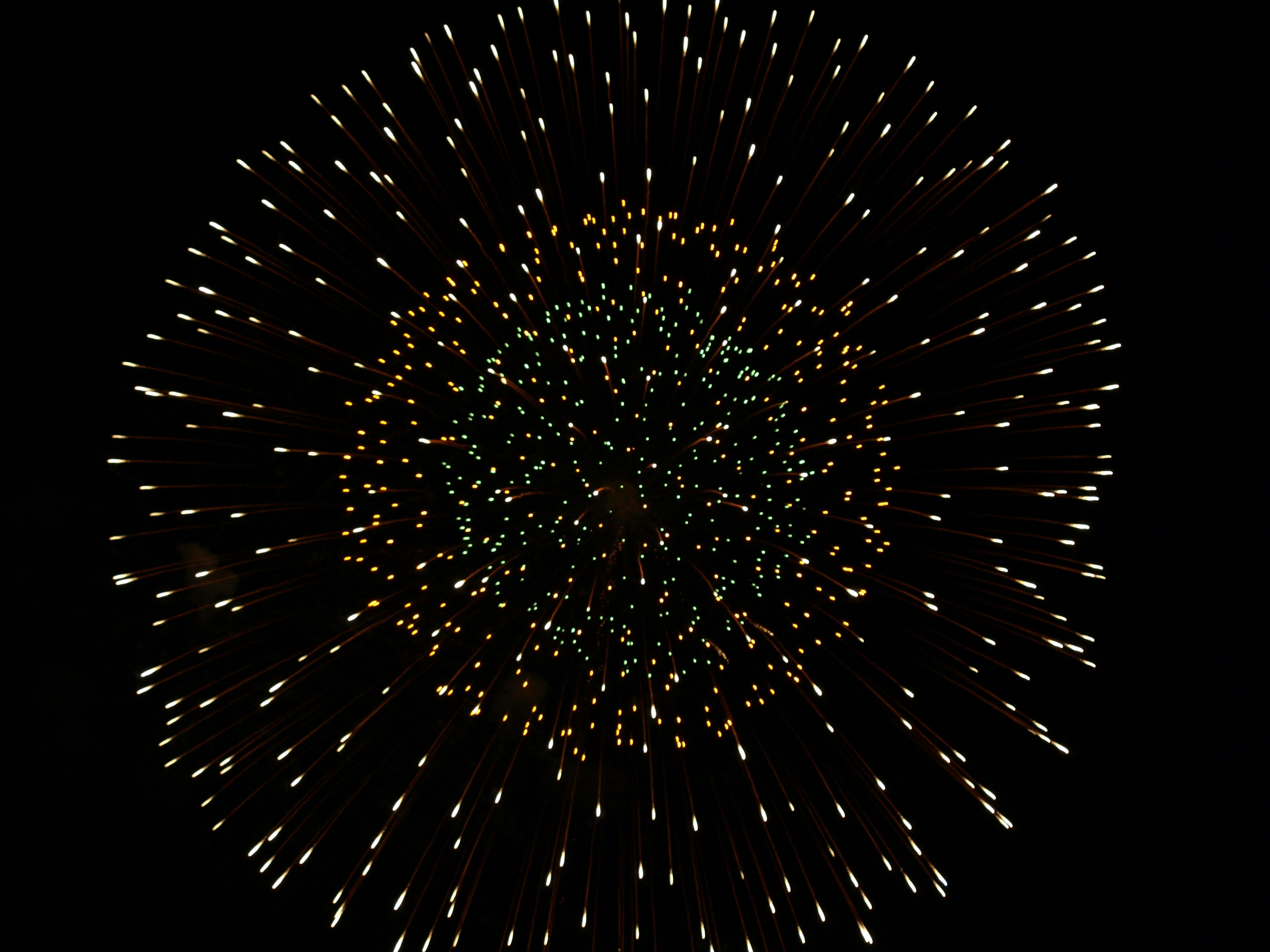 Colorful fireworks pattern expanding against a black background