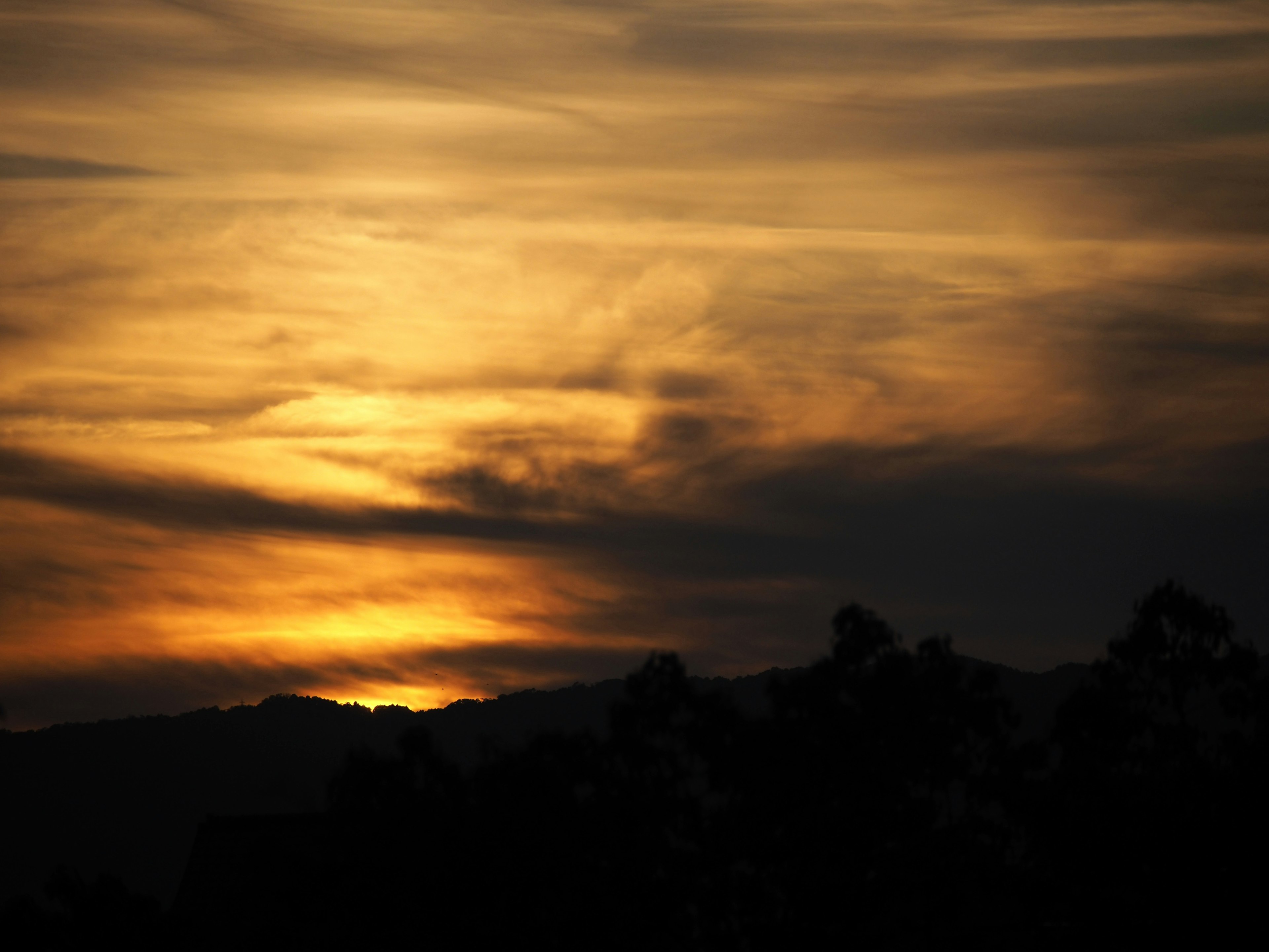 Vibrant sunset with orange and dark clouds