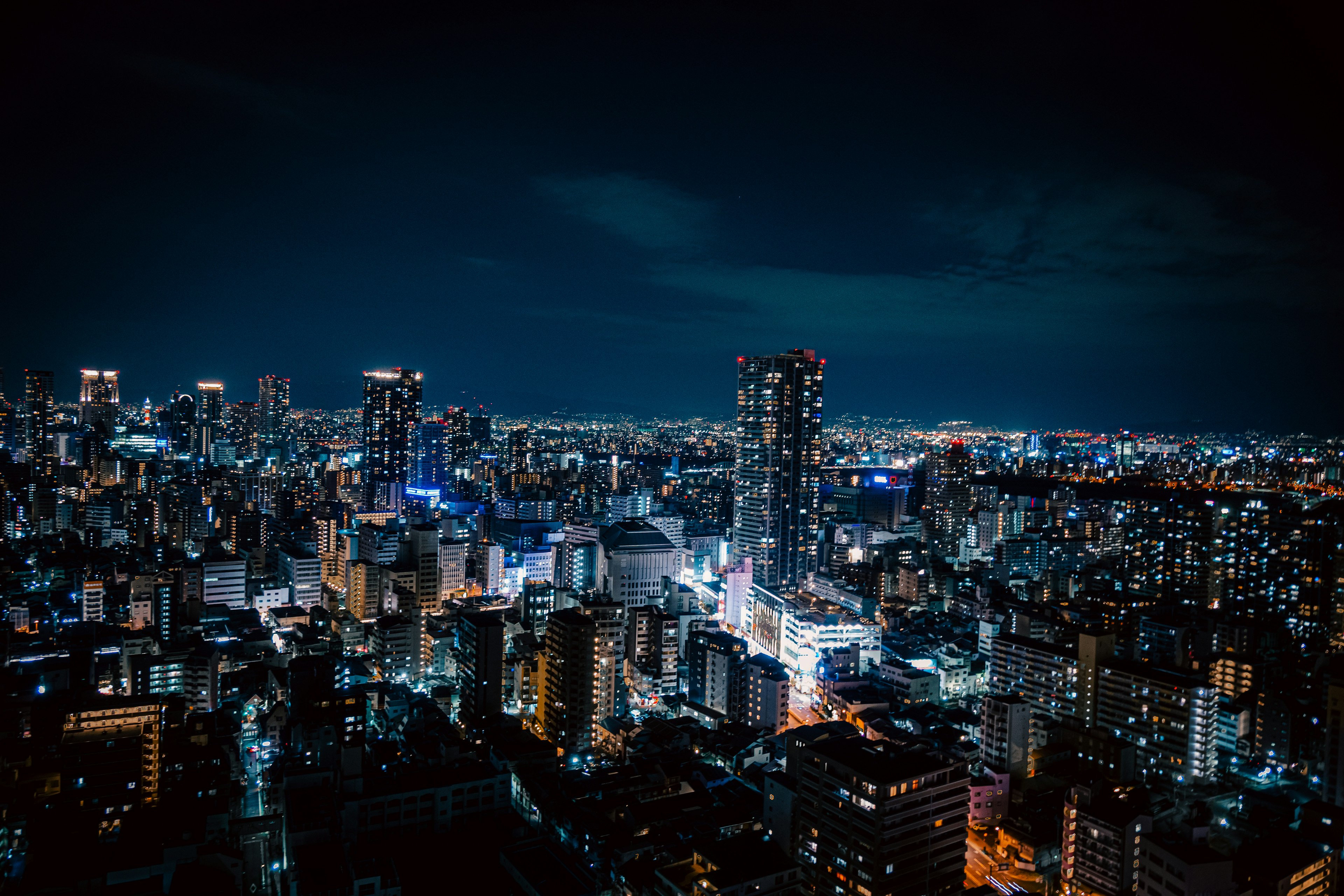 Pemandangan malam kota dengan gedung pencakar langit yang diterangi di Tokyo