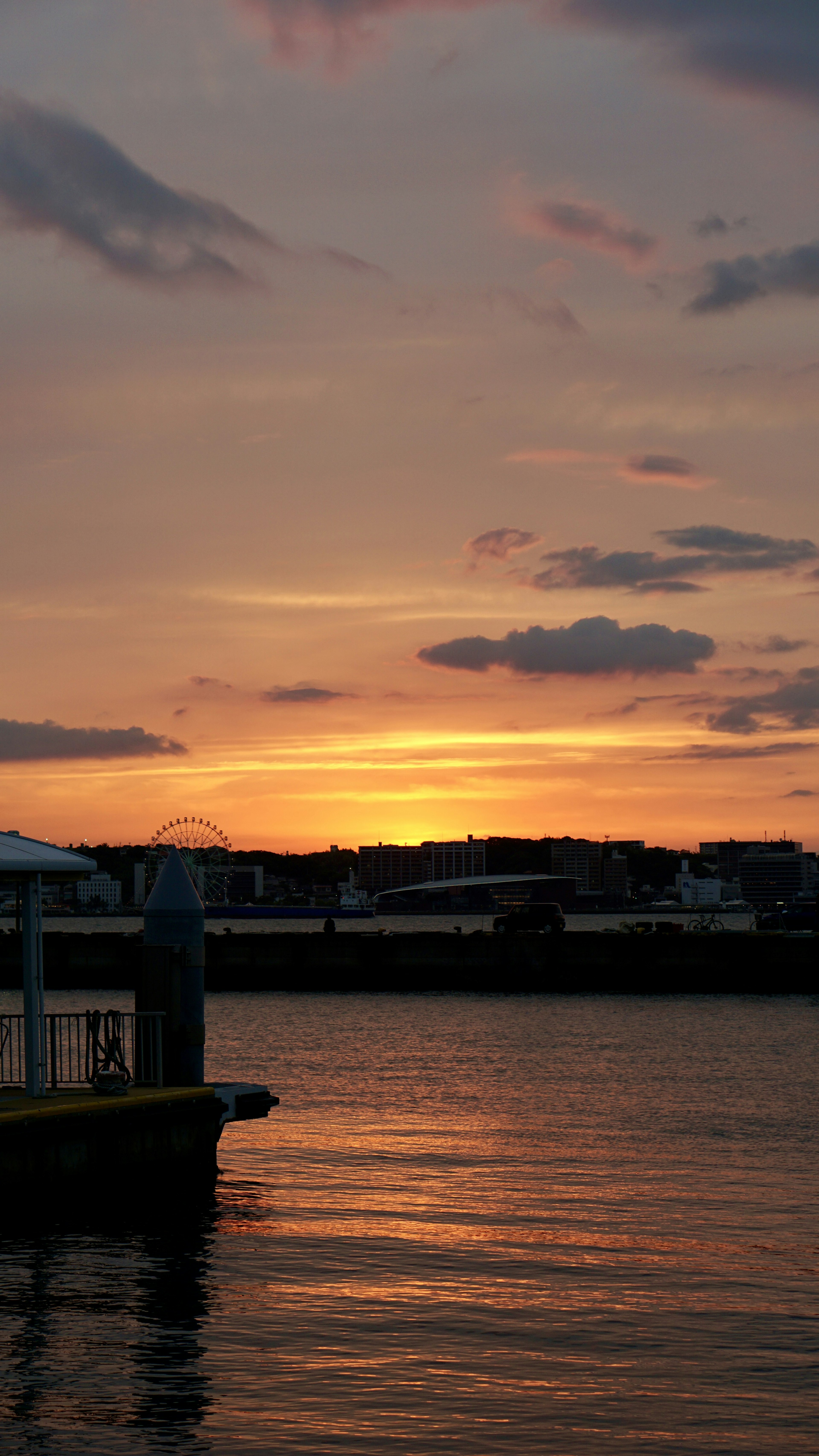 Beautiful landscape with sunset reflecting on the water dock visible in the foreground