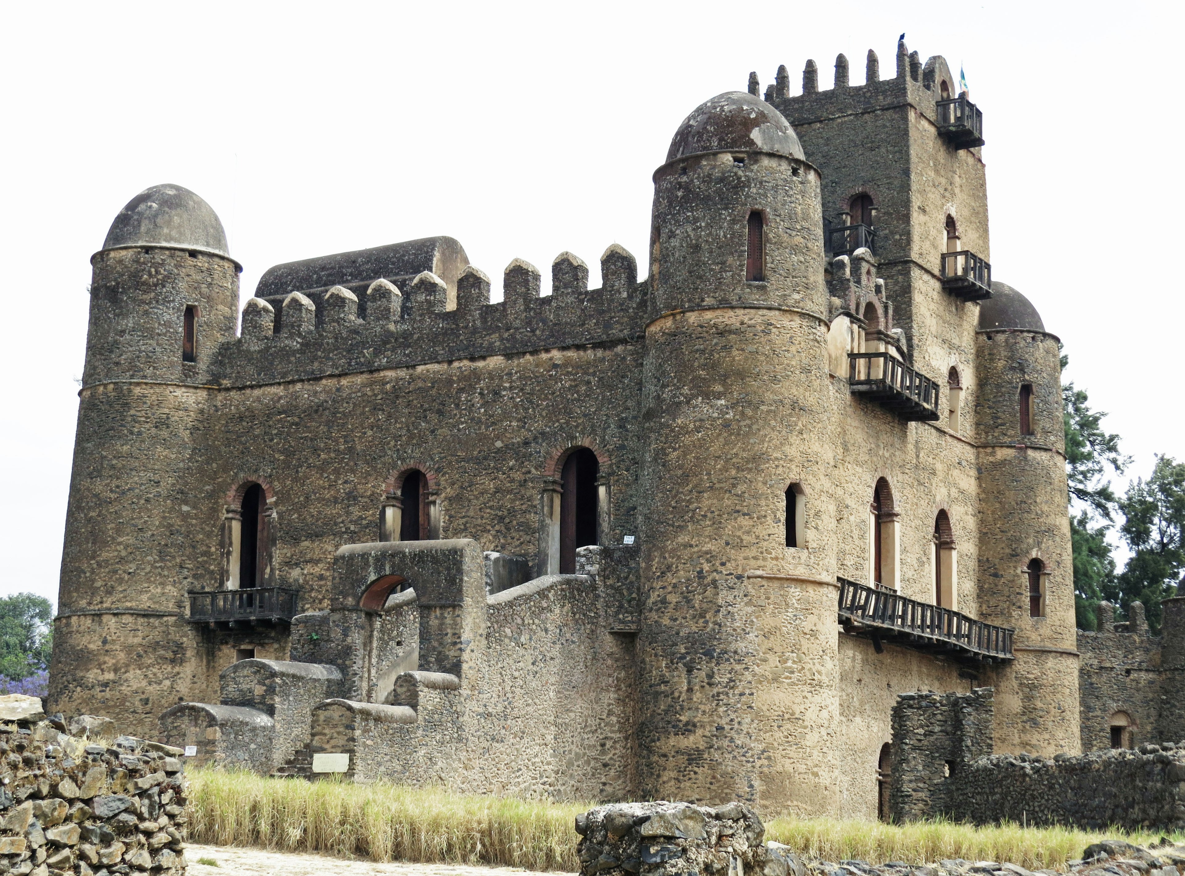 Ancient castle in Ethiopia surrounded by rubble and grass