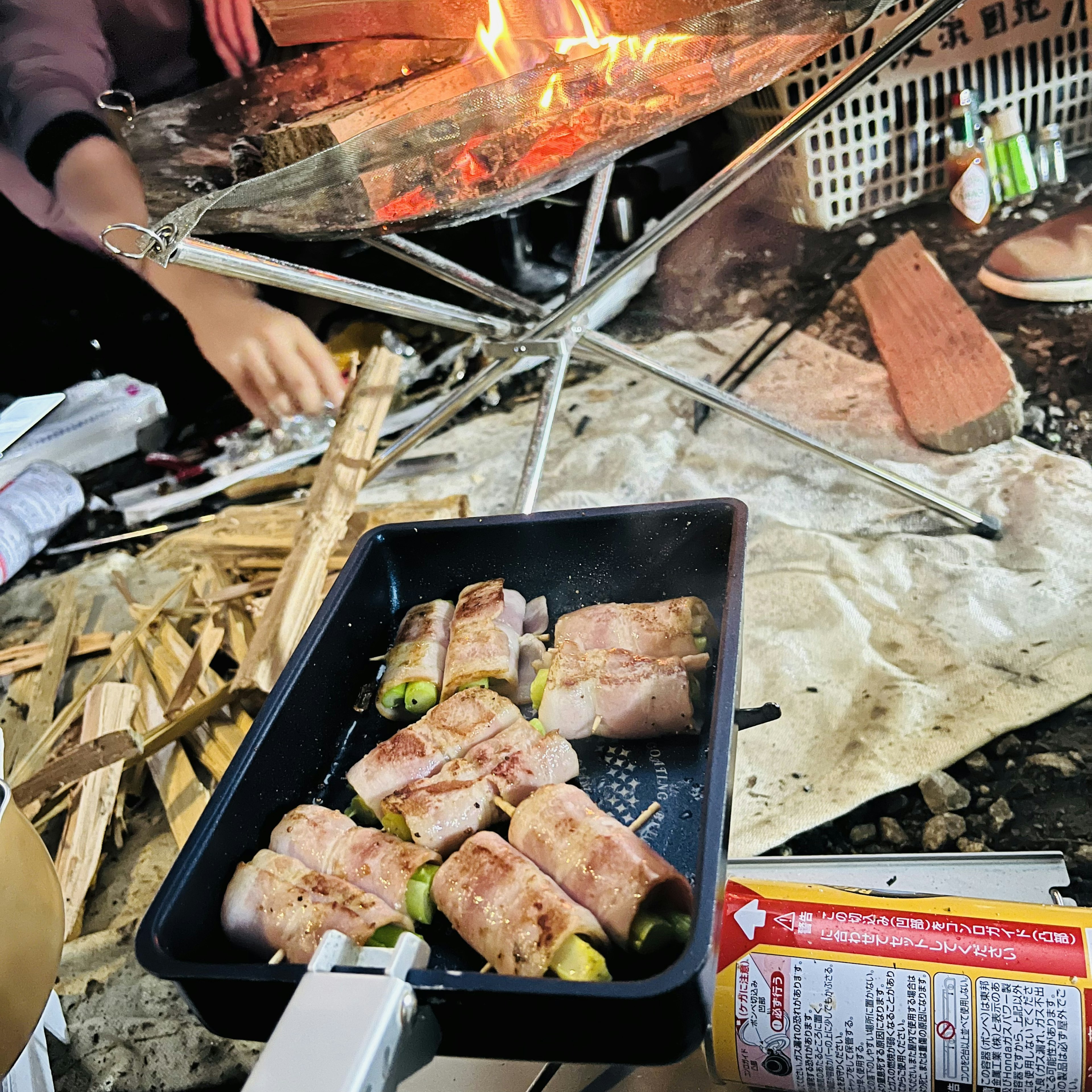 야외에서 불꽃이 있는 휴대용 그릴 위의 구운 음식