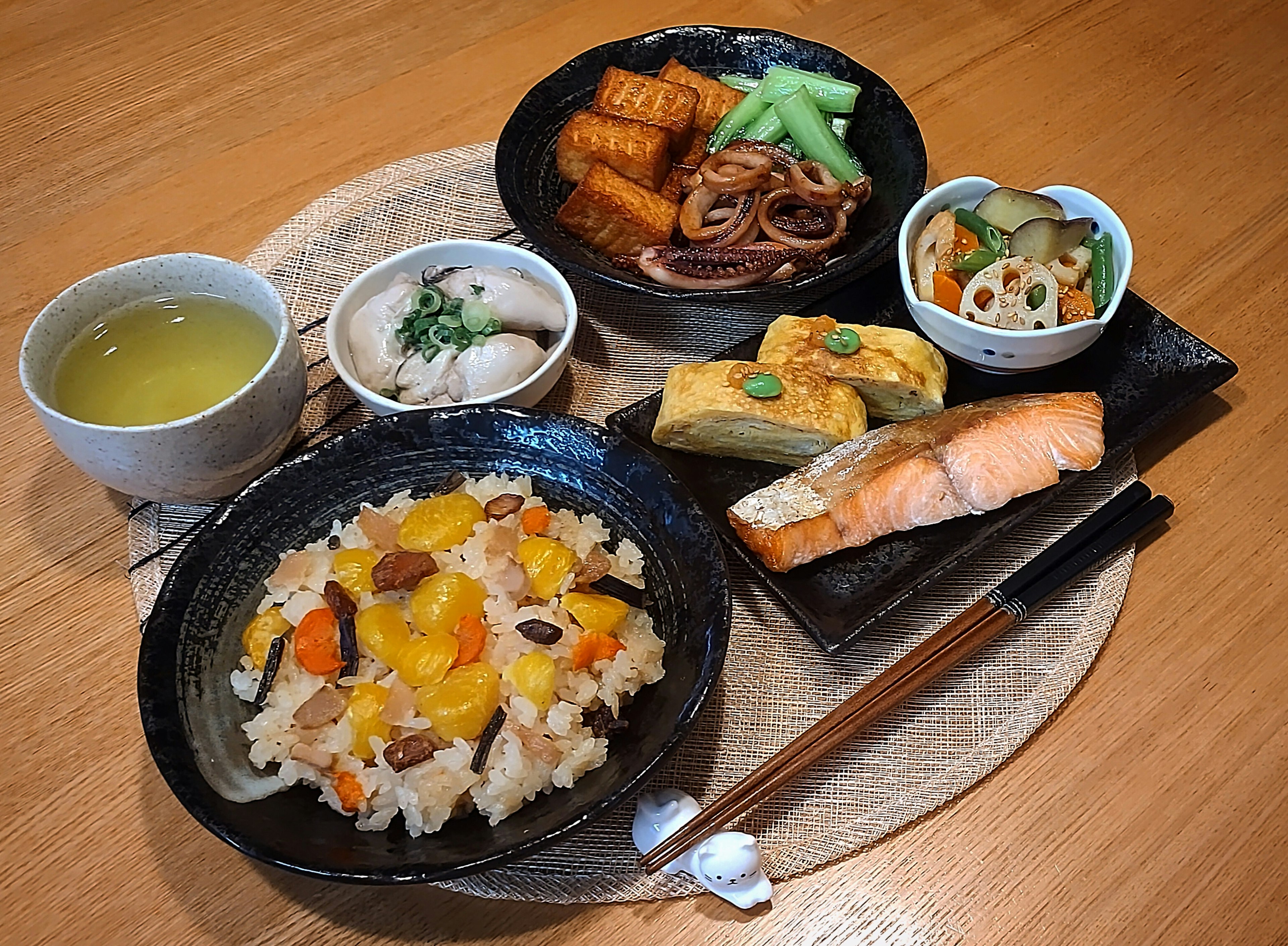 A beautifully arranged plate of Japanese cuisine on a wooden table