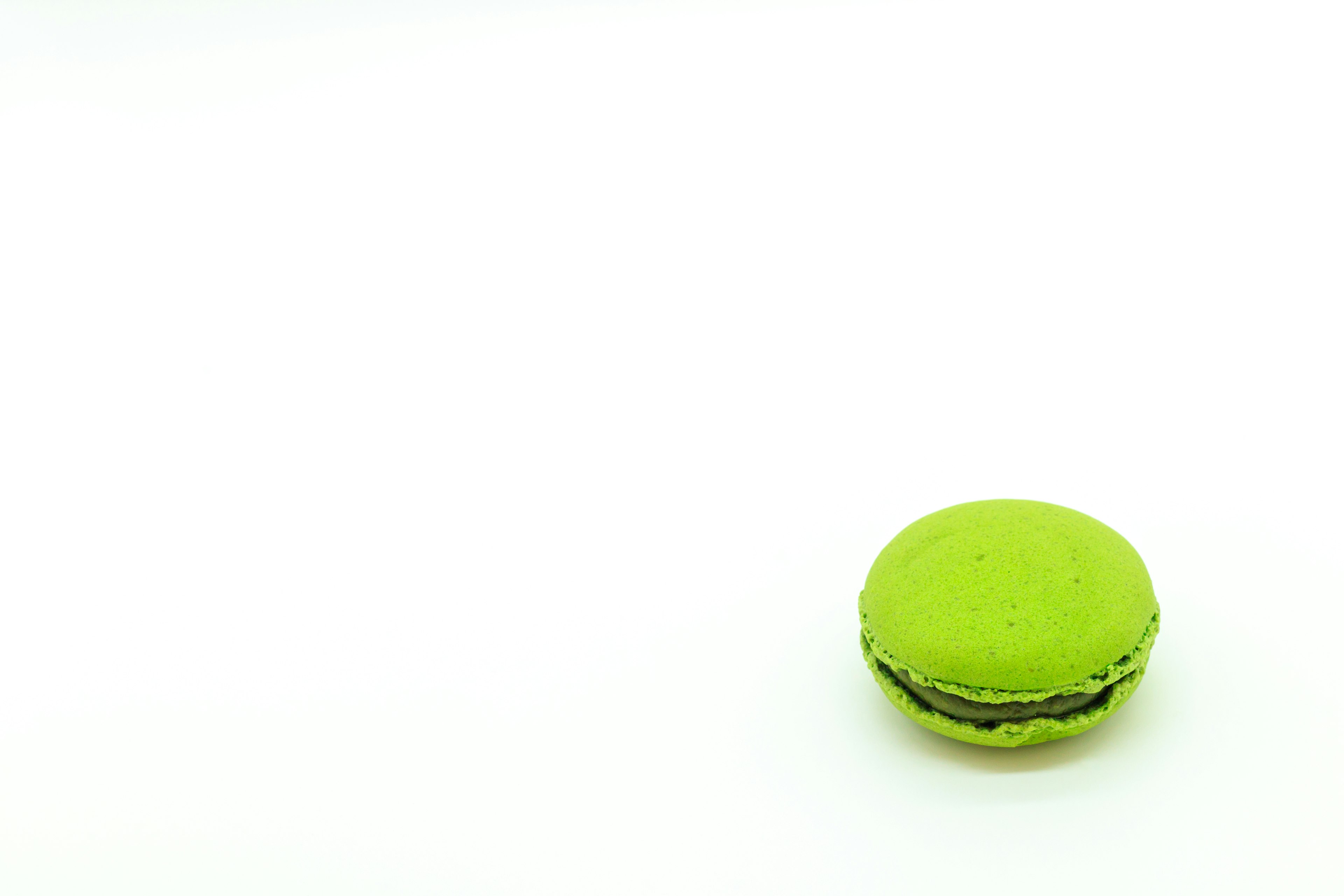 Heller grüner Macaron auf einem weißen Hintergrund