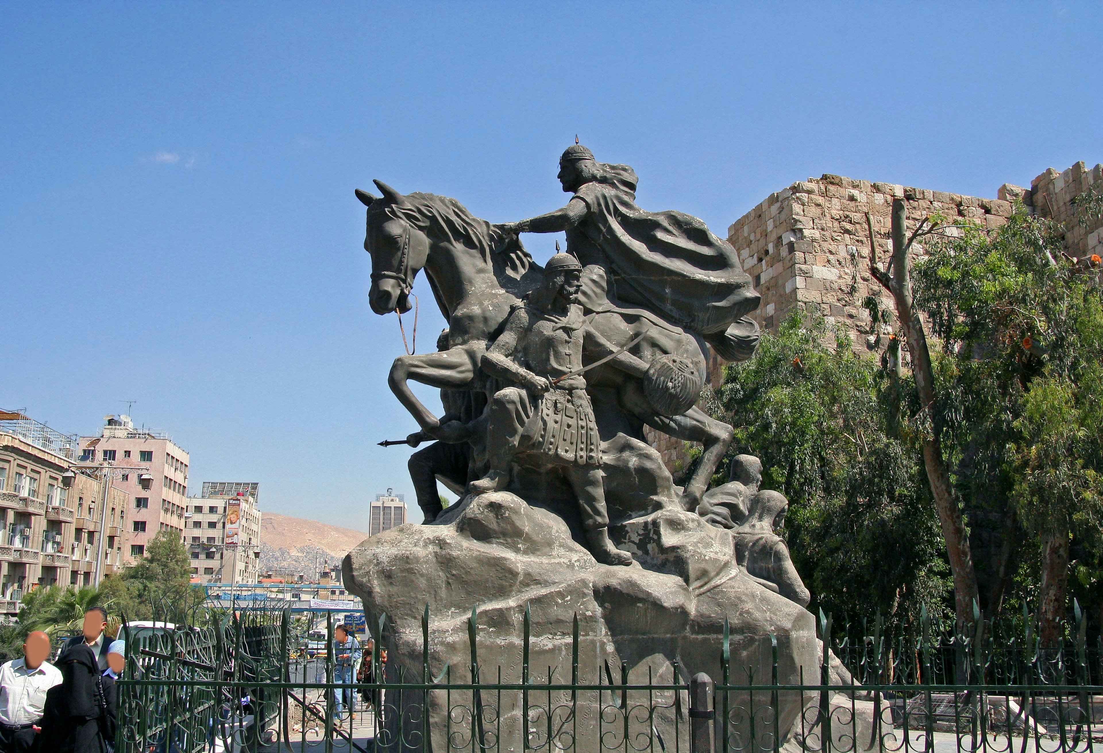 Statue d'un guerrier à cheval entourée de bâtiments