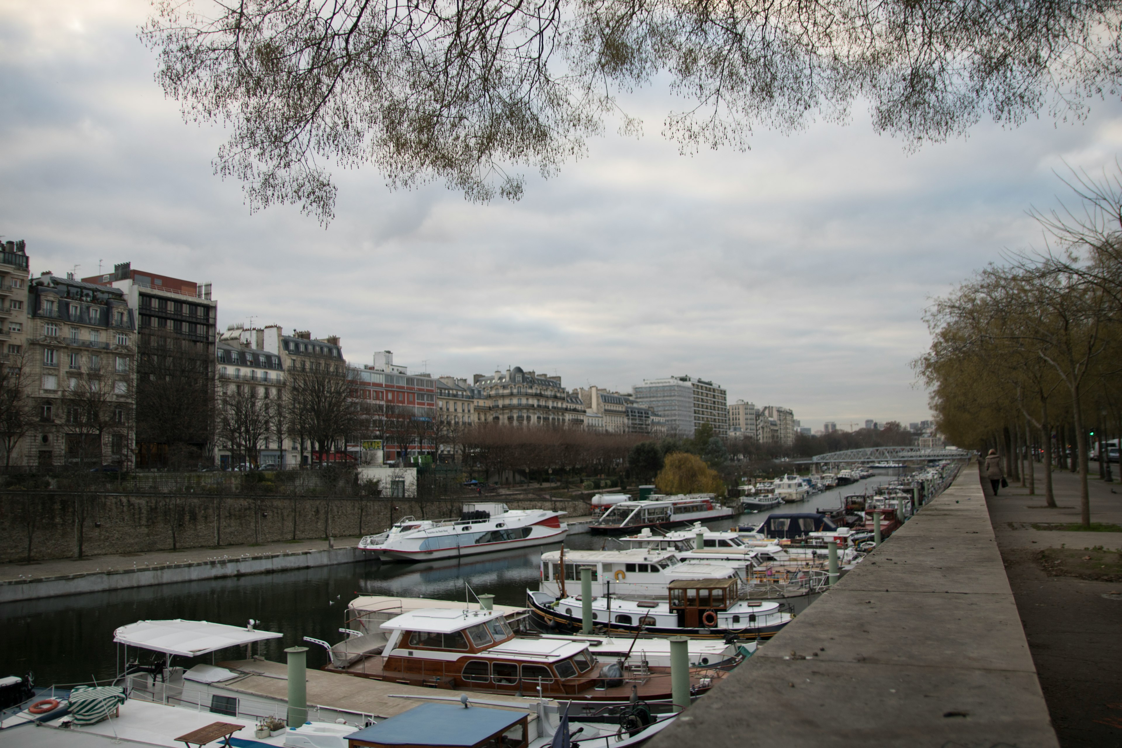 View of boats along the Seine River with Parisian buildings