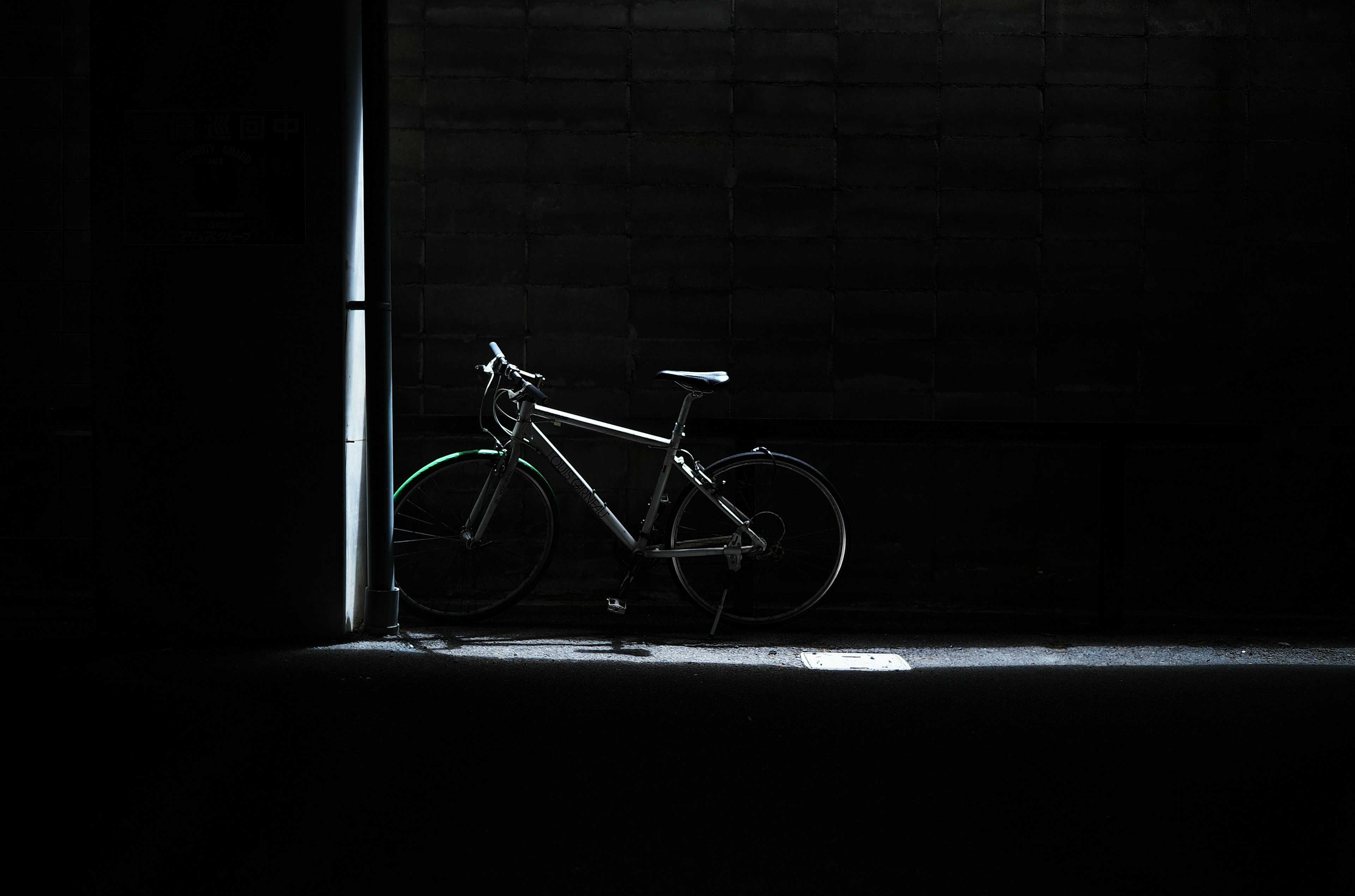 Silhouette of a bicycle illuminated against a dark background